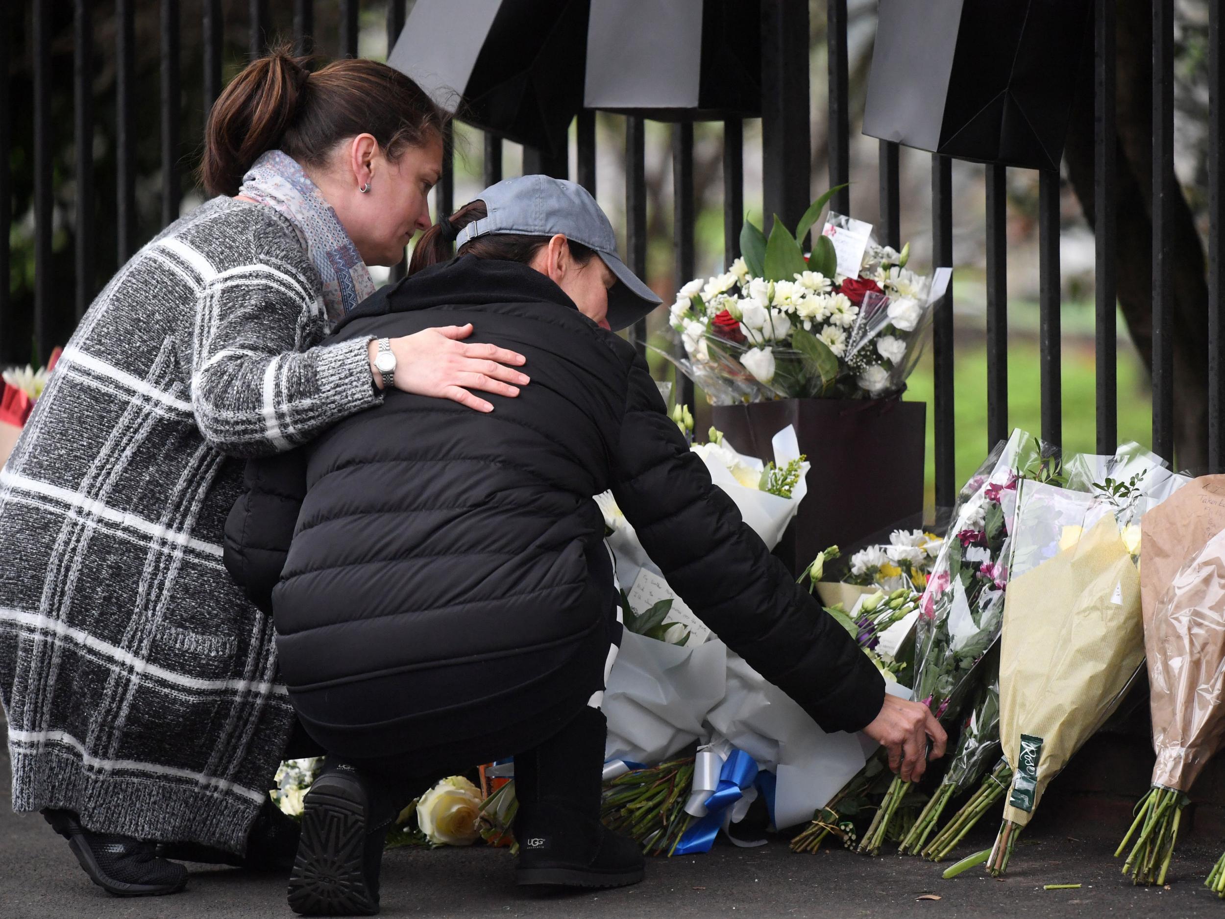 People leave floral tributes in Shepiston Lane, Hayes, where three teenage boys died after a car mounted the pavement