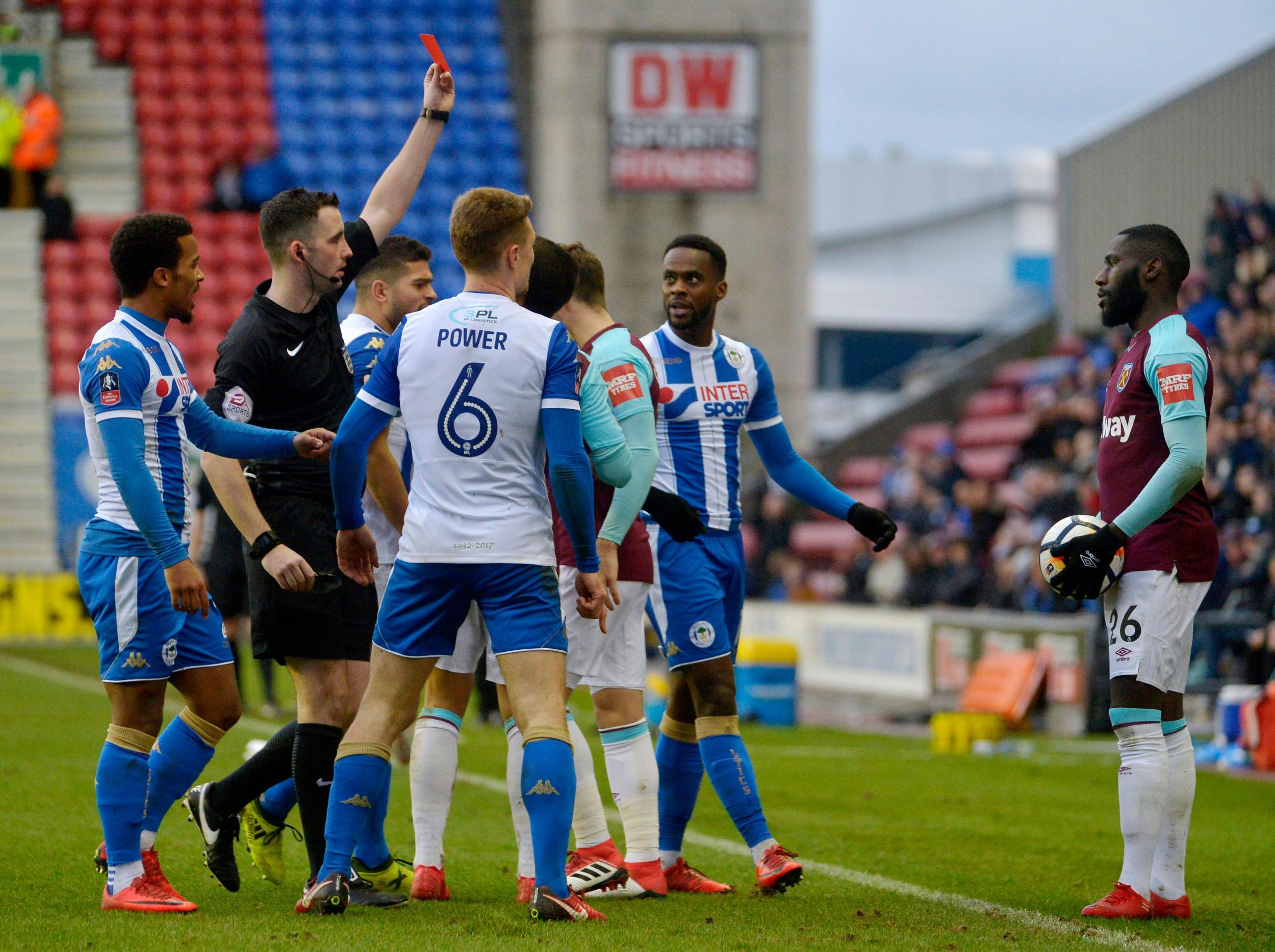 Will Grigg scored twice to dump 10-man West Ham out of the FA Cup