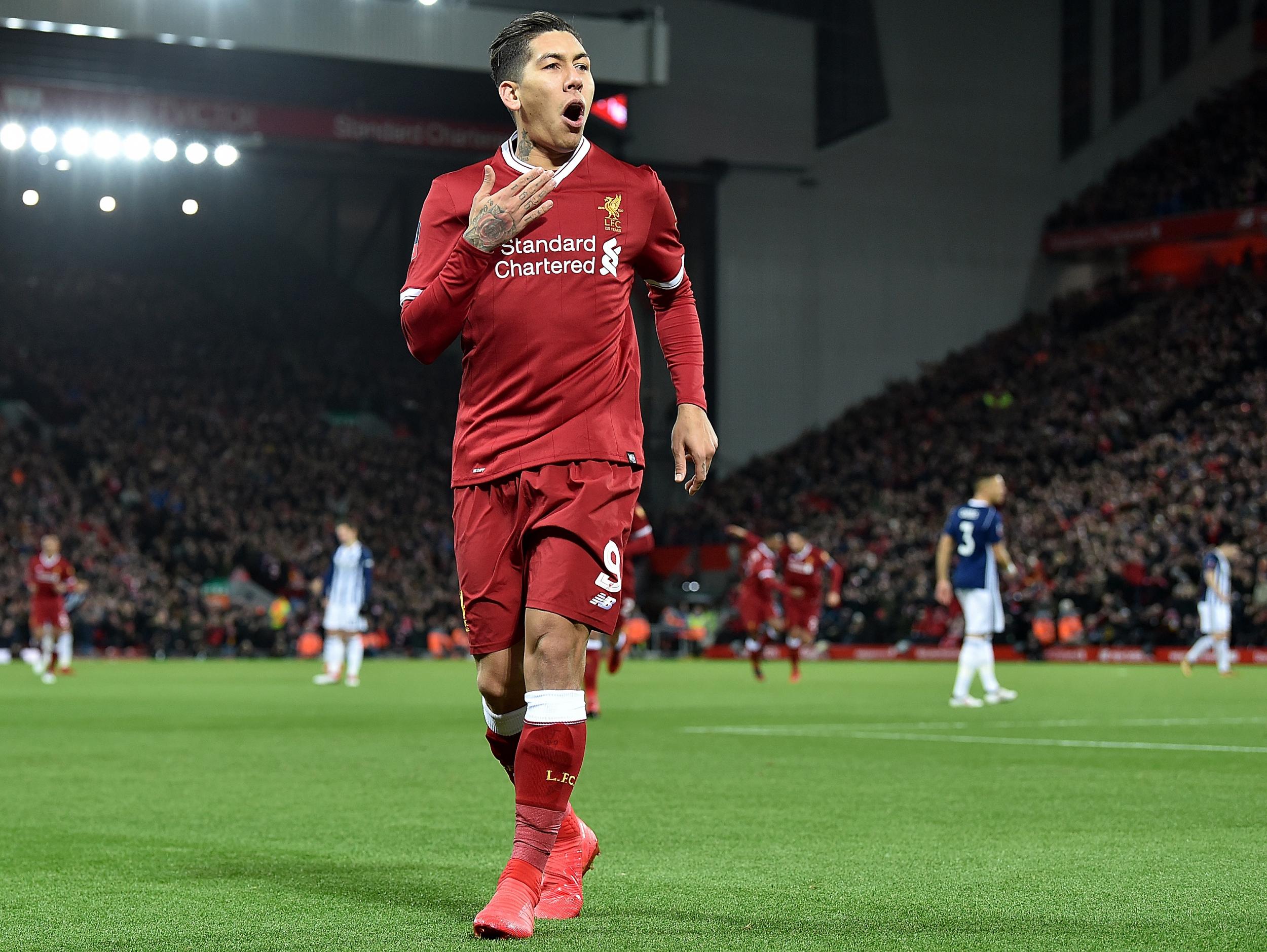 &#13;
Firmino celebrates his delicious chip against West Brom &#13;