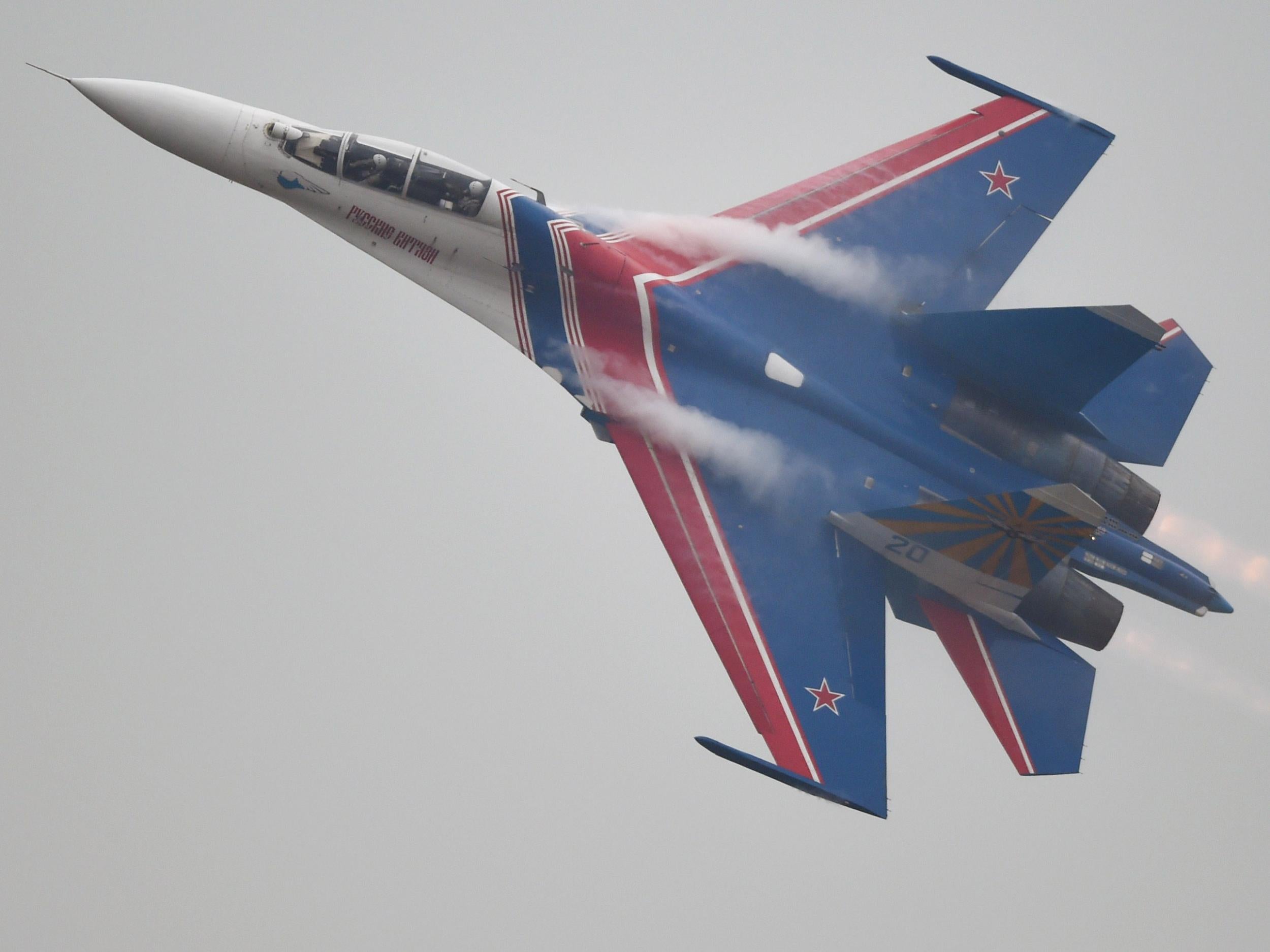 The Russian Airforce aerobatic team performs in their SU-27 jets