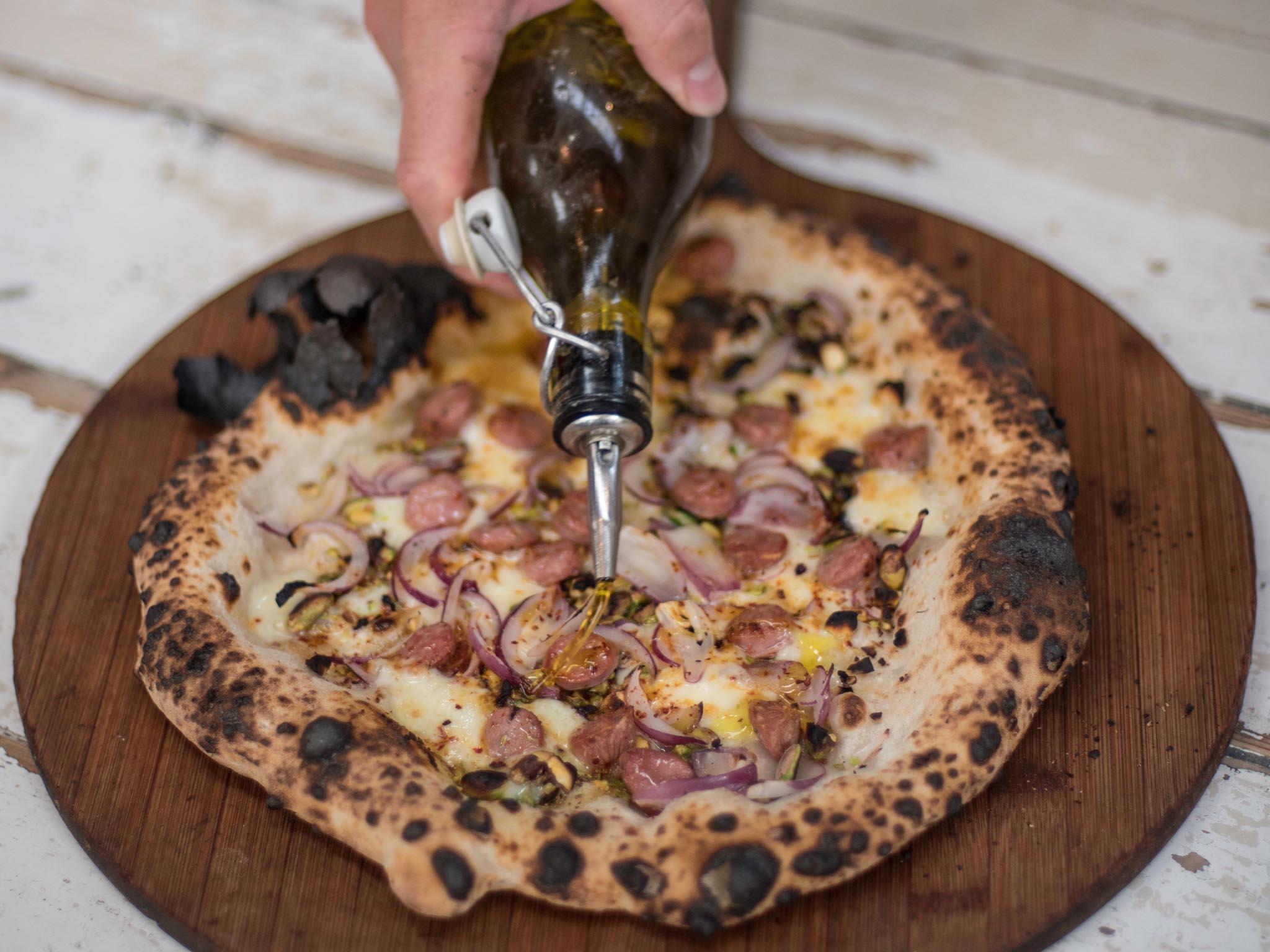 Honest Crust Pizza is cooked in a wood fire oven at Altrincham Market (Claire Harrison)