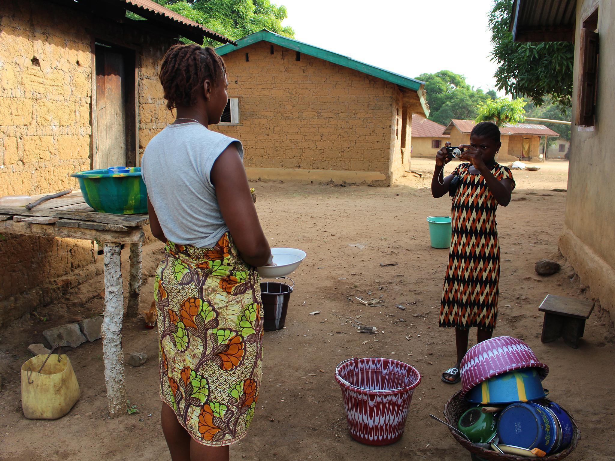 Jeneba takes a photo as part of a project providing an insight into life in the jungle as well as the work WaterAid is doing to build clean water and toilet facilities after years of hardship