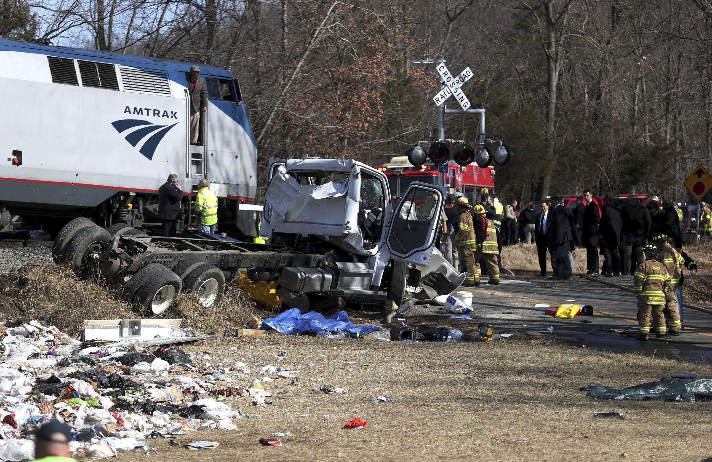 Emergency personnel work at the scene of a train crash involving a garbage truck in Crozet, Virginia