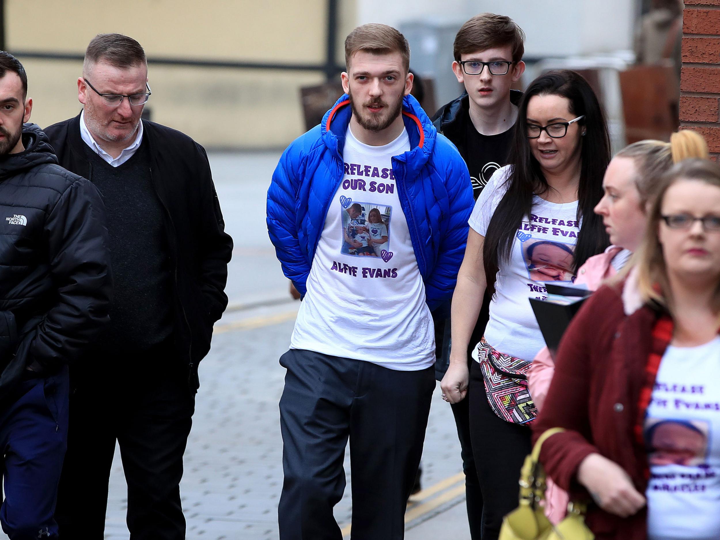 Tom Evans (centre) and his partner Kate James have changed lawyers seven times during their fight to keep baby Alfie alive