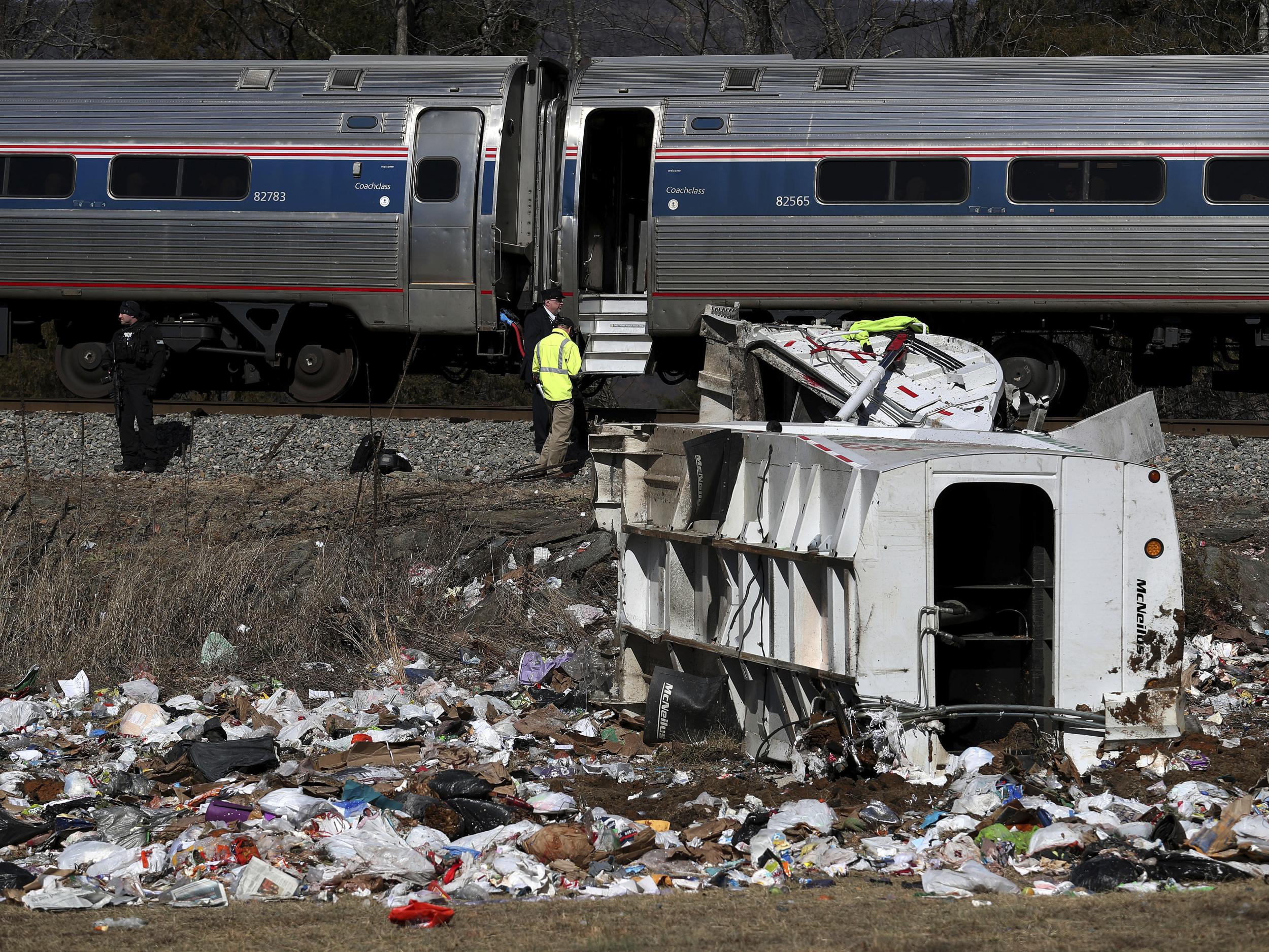 Emergency personnel work at the scene of a train crash involving a garbage truck in Crozet, Virginia