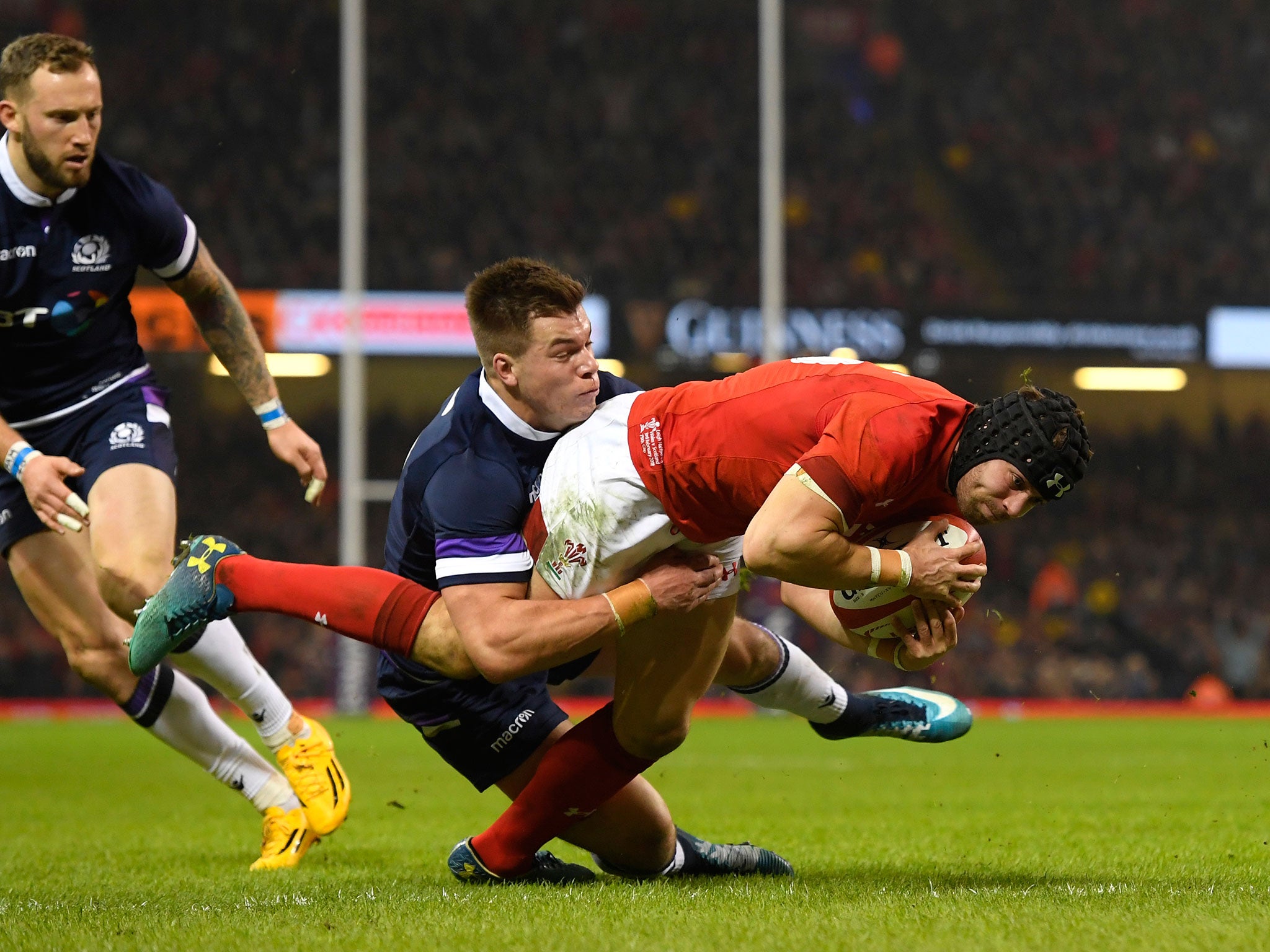 Huw Jones is unable to stop Leigh Halfpenny from touching down for Wales' second try