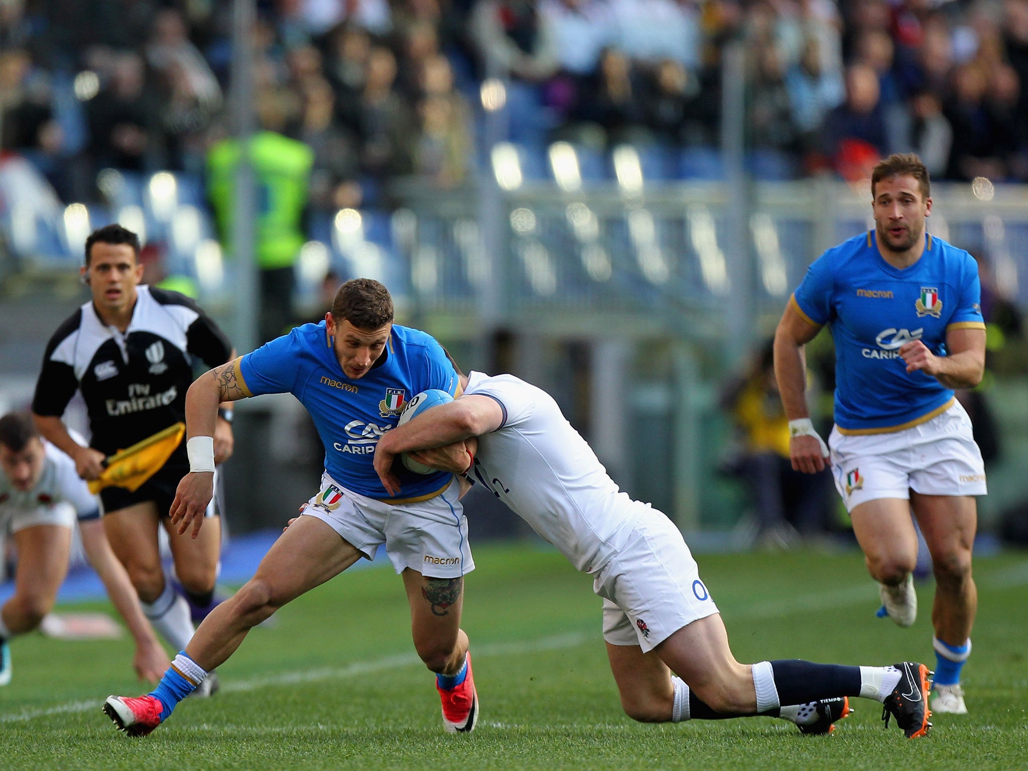 Tommaso Benvenuti is tackled by Owen Farrell