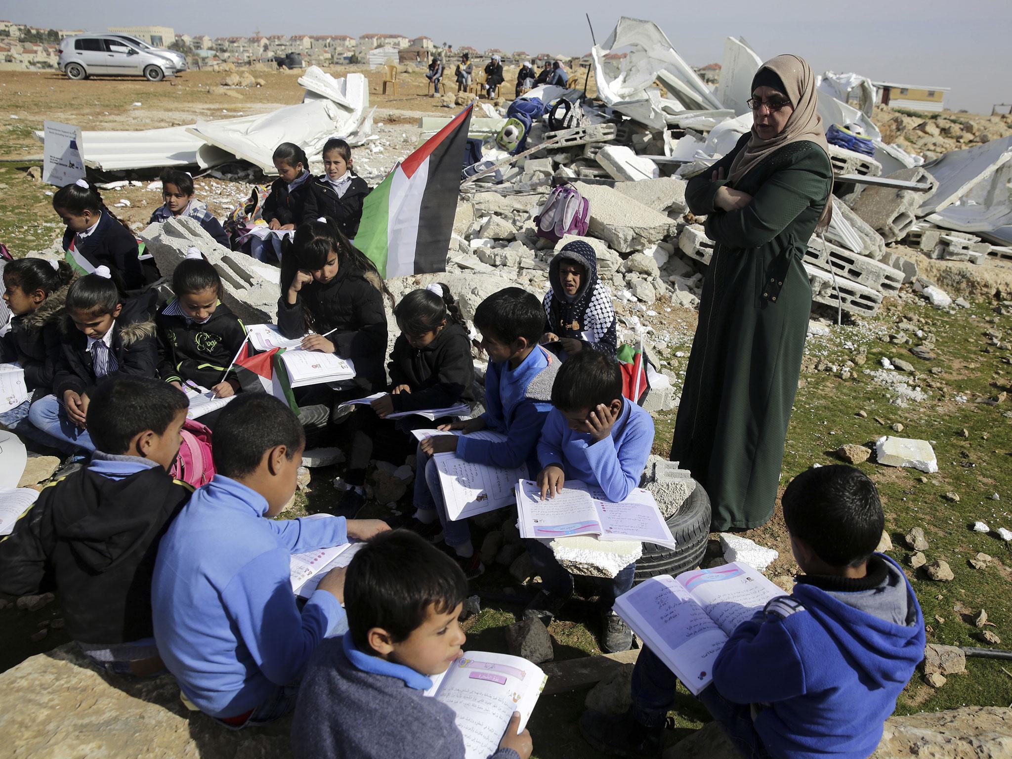 Bedouin children attend improvised class in the village of Abu Nuwar, West Bank, after the Israeli army demolished their two-classroom school in the West Bank on Sunday