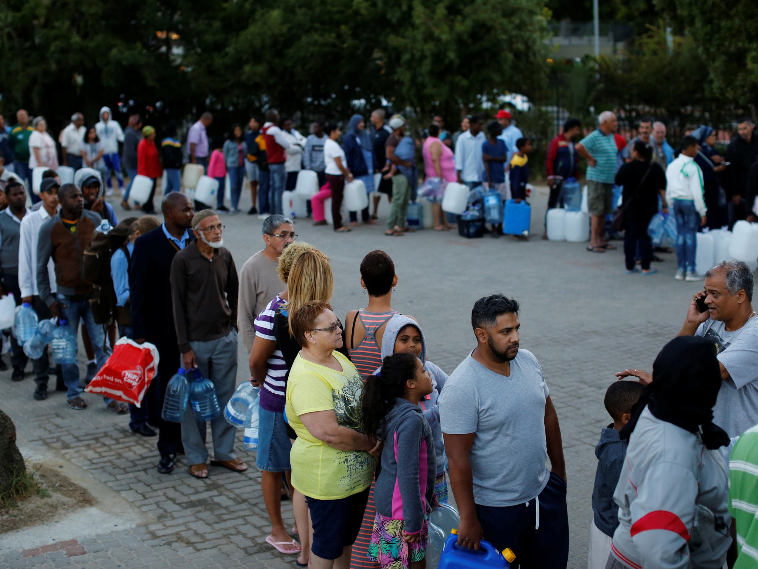 In the suburb of Newlands, people are queueing to collect water