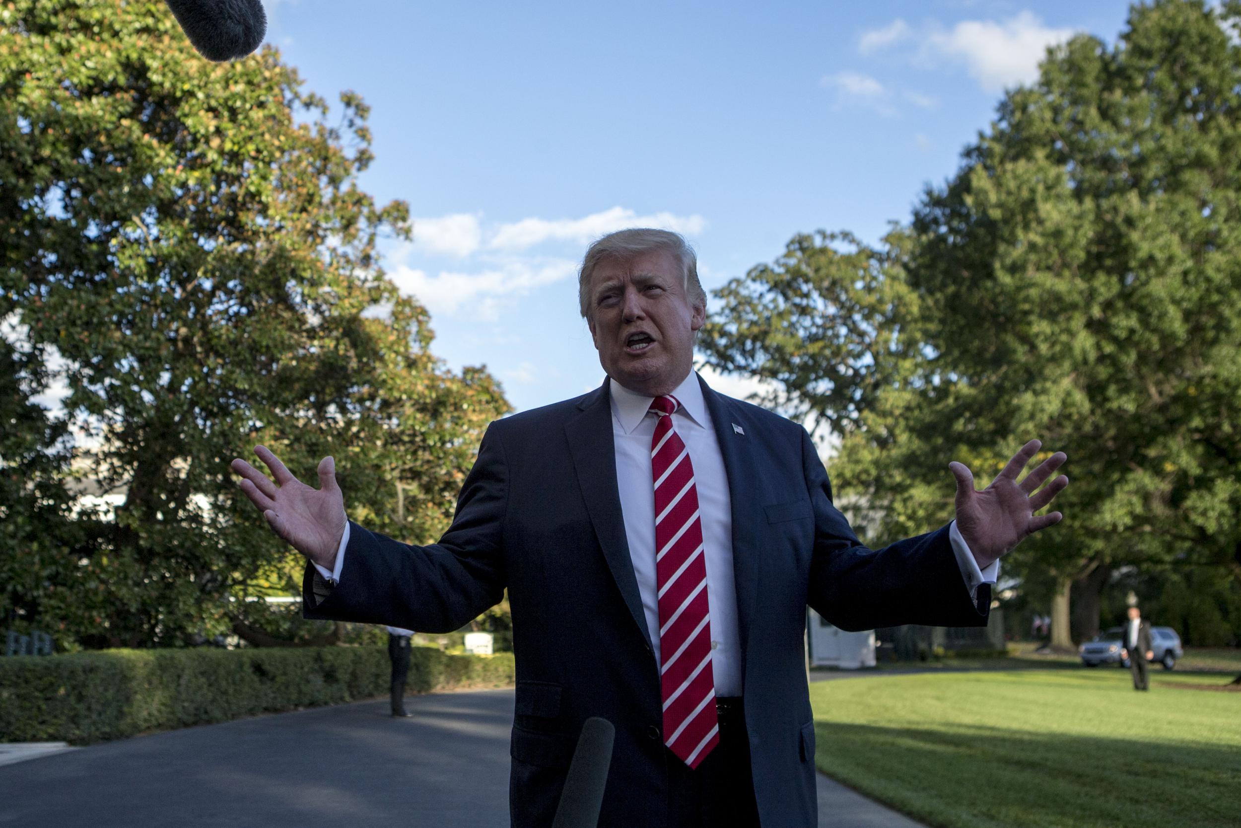 US President Donald Trump speaks with reporters outside the White House prior to his departure aboard Marine One