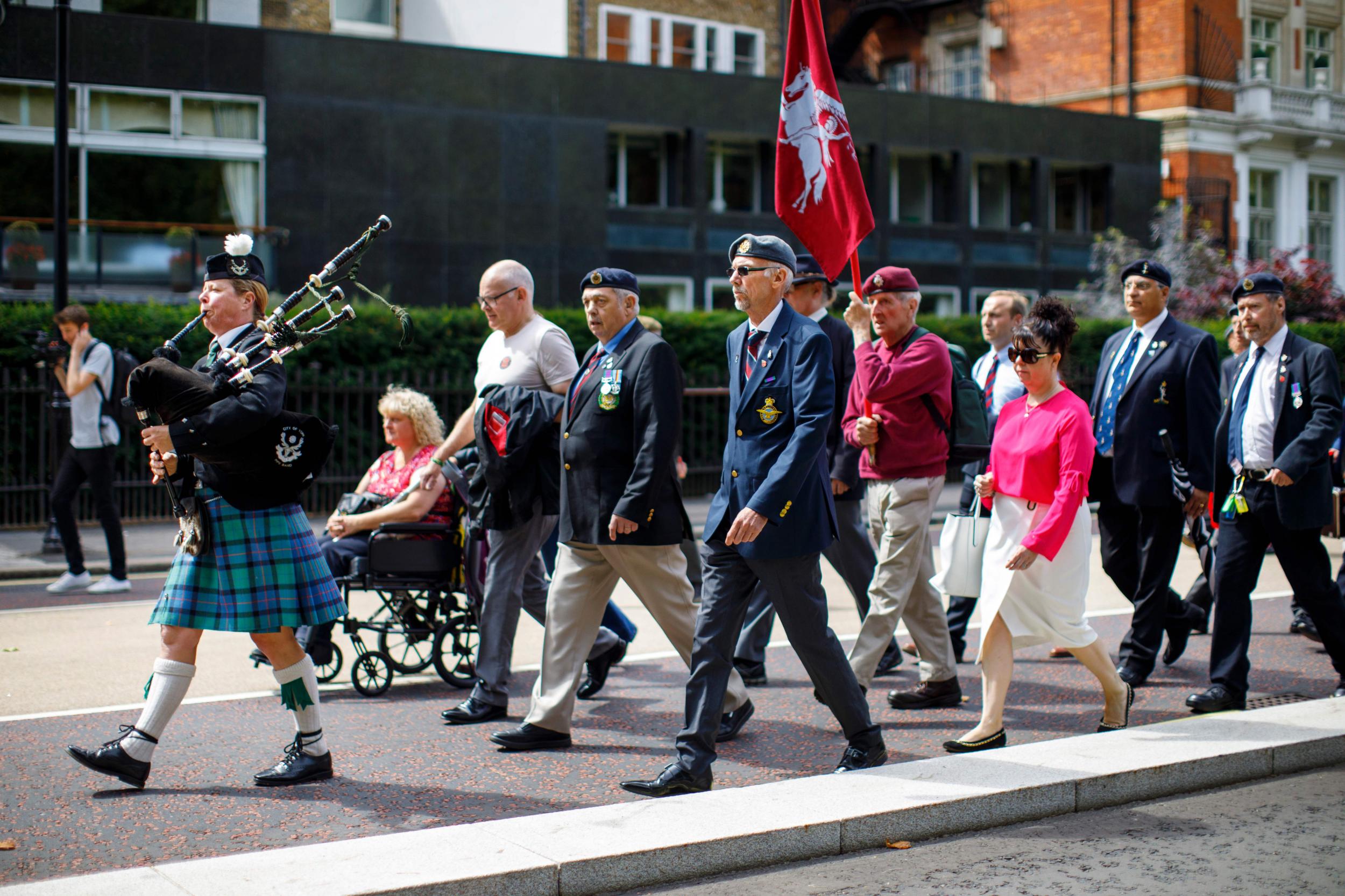 Supporters and former soldiers march from Hyde Park Barracks to demand justice for those who died in a 1982 IRA bomb attack