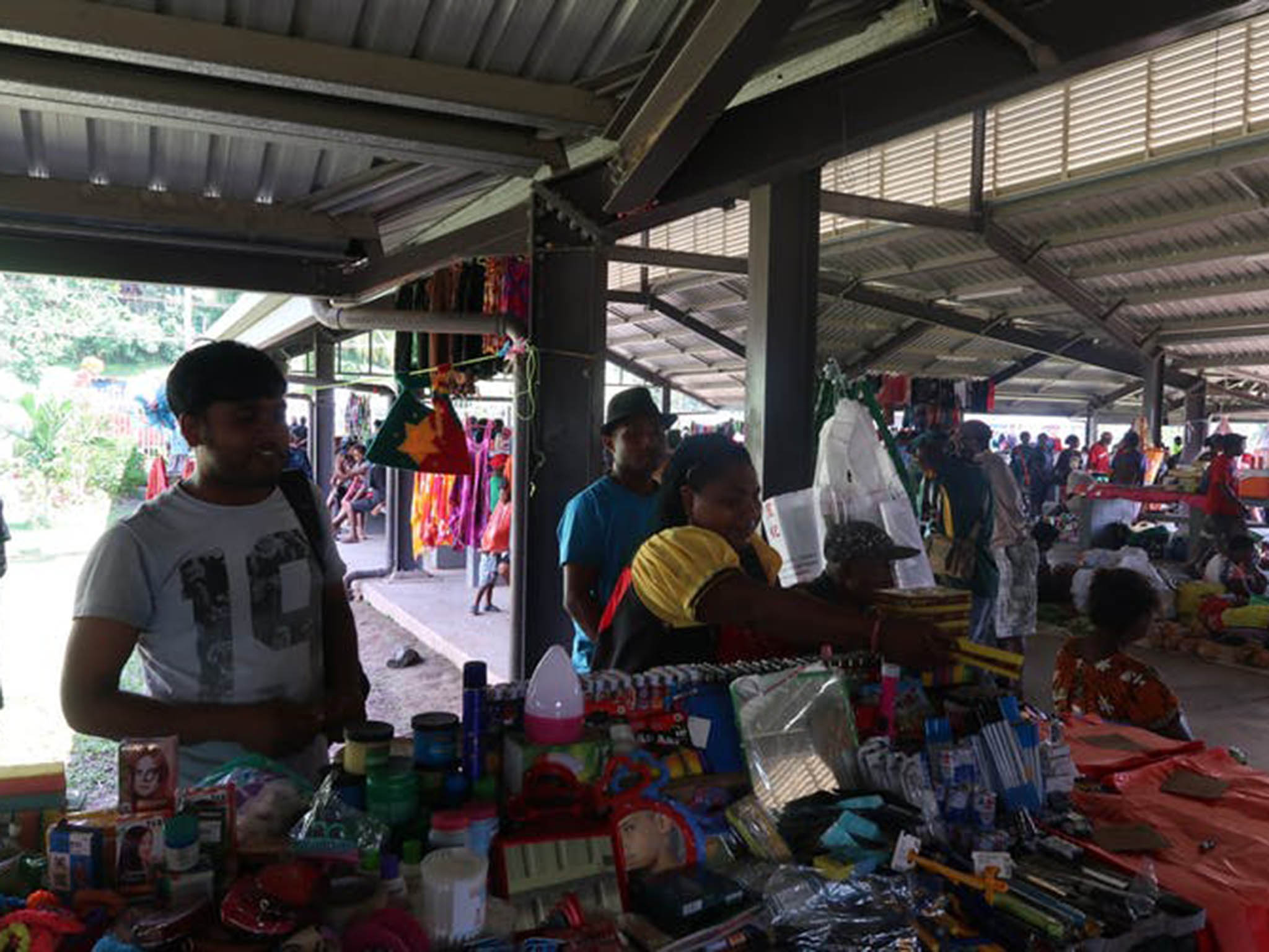 Locals and newcomers trade together at the market