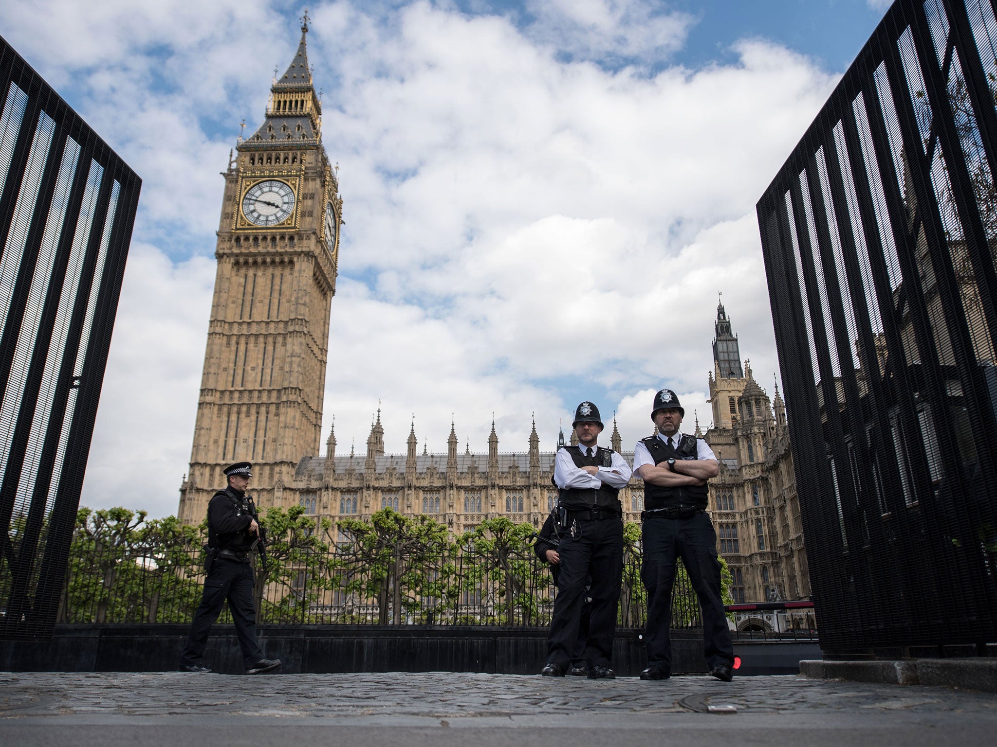 Armed police officers stand guard outside the Houses of Parliament