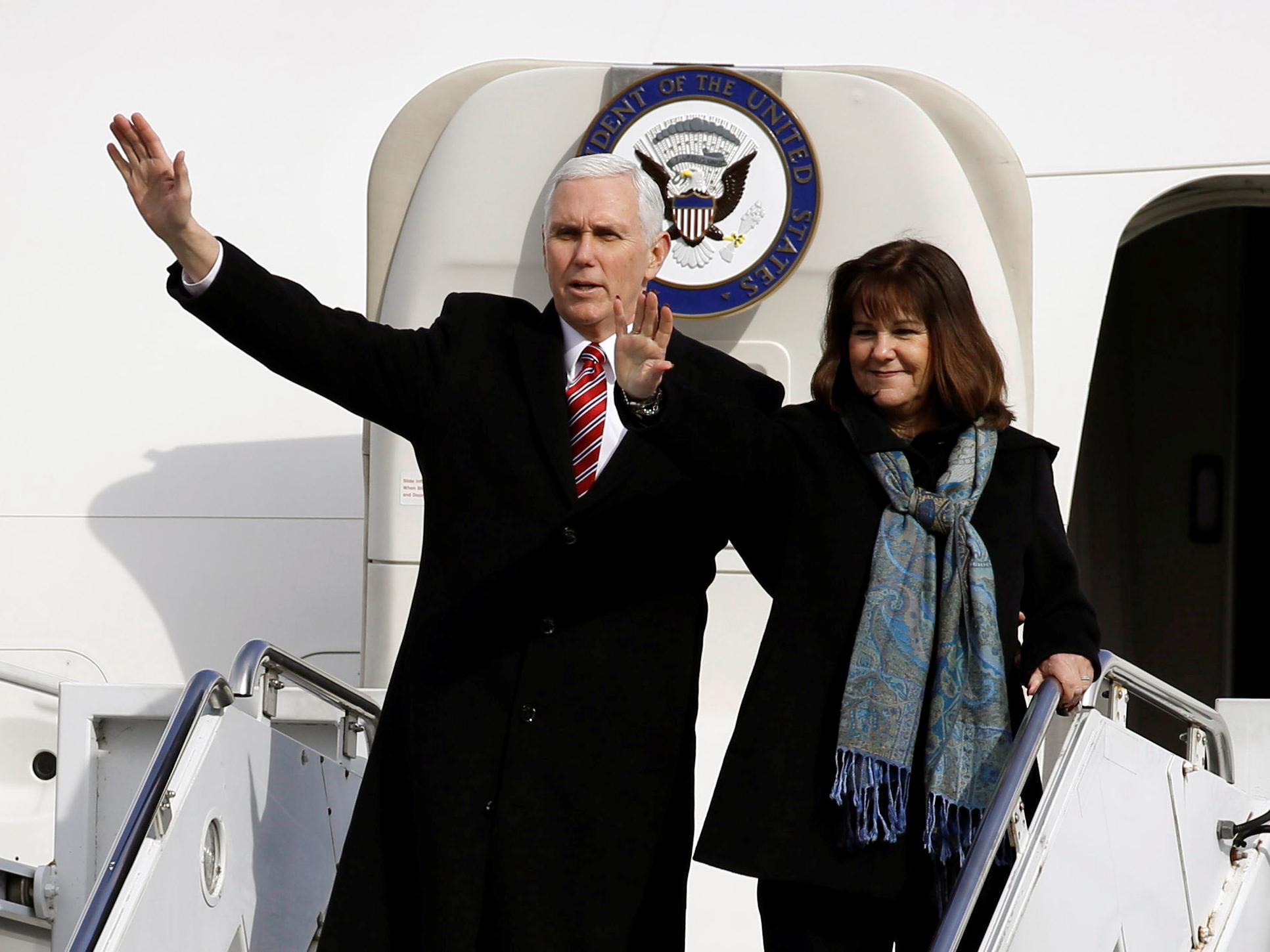 US Vice President Mike Pence and his wife Karen wave as they depart for South Korea at Yokota US Air Force Base in Fussa on the outskirts of Tokyo, Japan