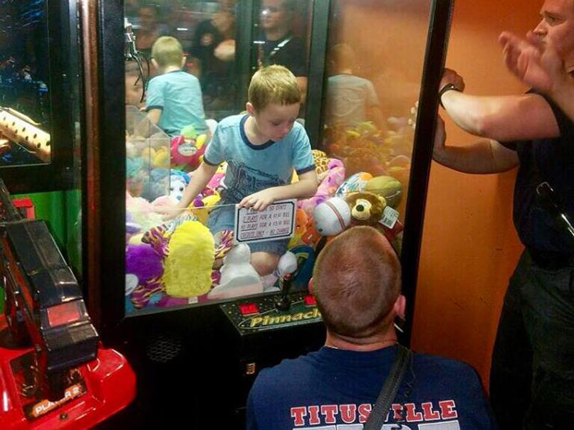 A young boy had to be rescued after climbing into a claw machine to retrieve a toy