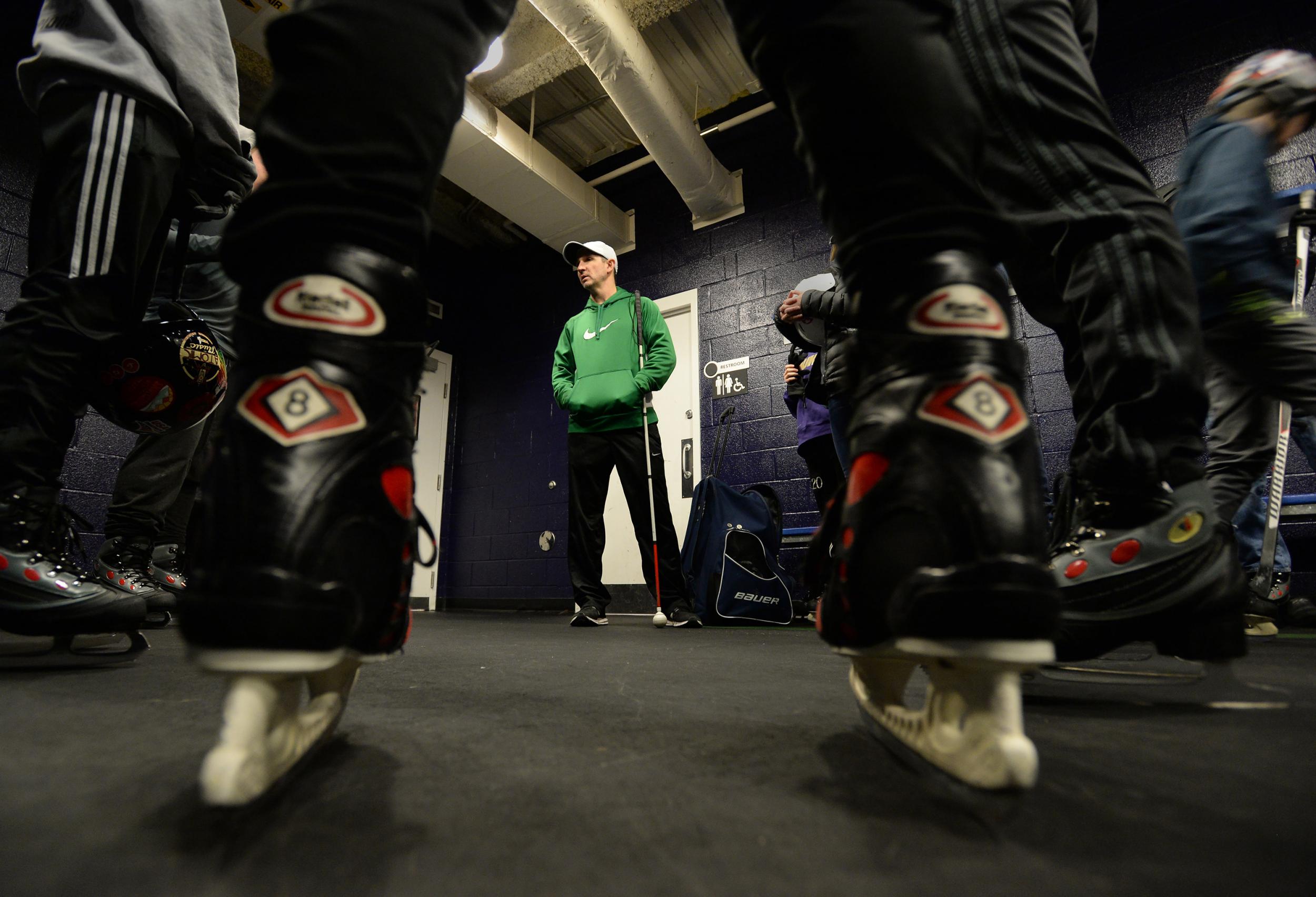 Kevin Brown gives instructions to skaters during a family-and-friends skating session