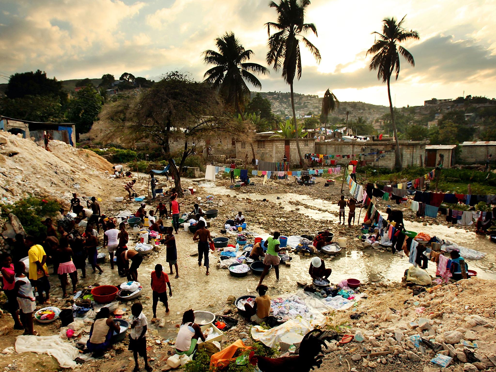 Survivors of the 2010 earthquake that killed more than 200,000 people in Haiti wash their clothes in Port au Prince