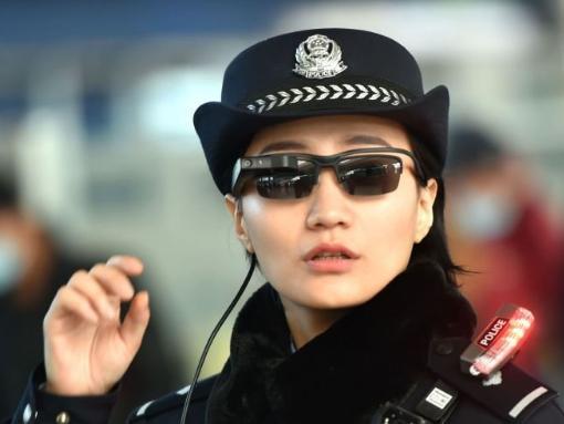 This photo taken on 5 February 2018 shows a police officer wearing a pair of smart glasses with a facial recognition system at Zhengzhou East Railway Station in Zhengzhou in China's central Henan province