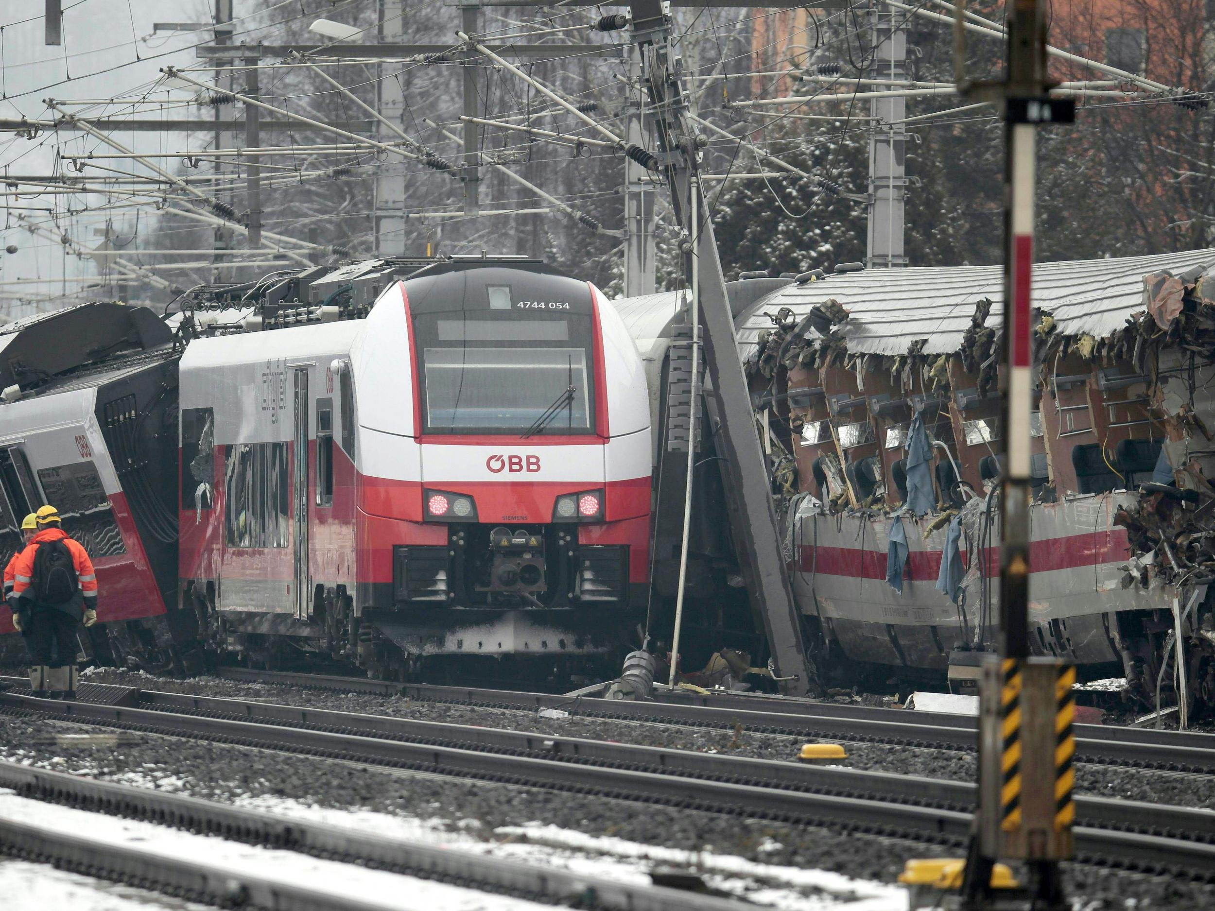 Rescuers at the site where two passenger trains collided in Niklasdorf, central Austria.