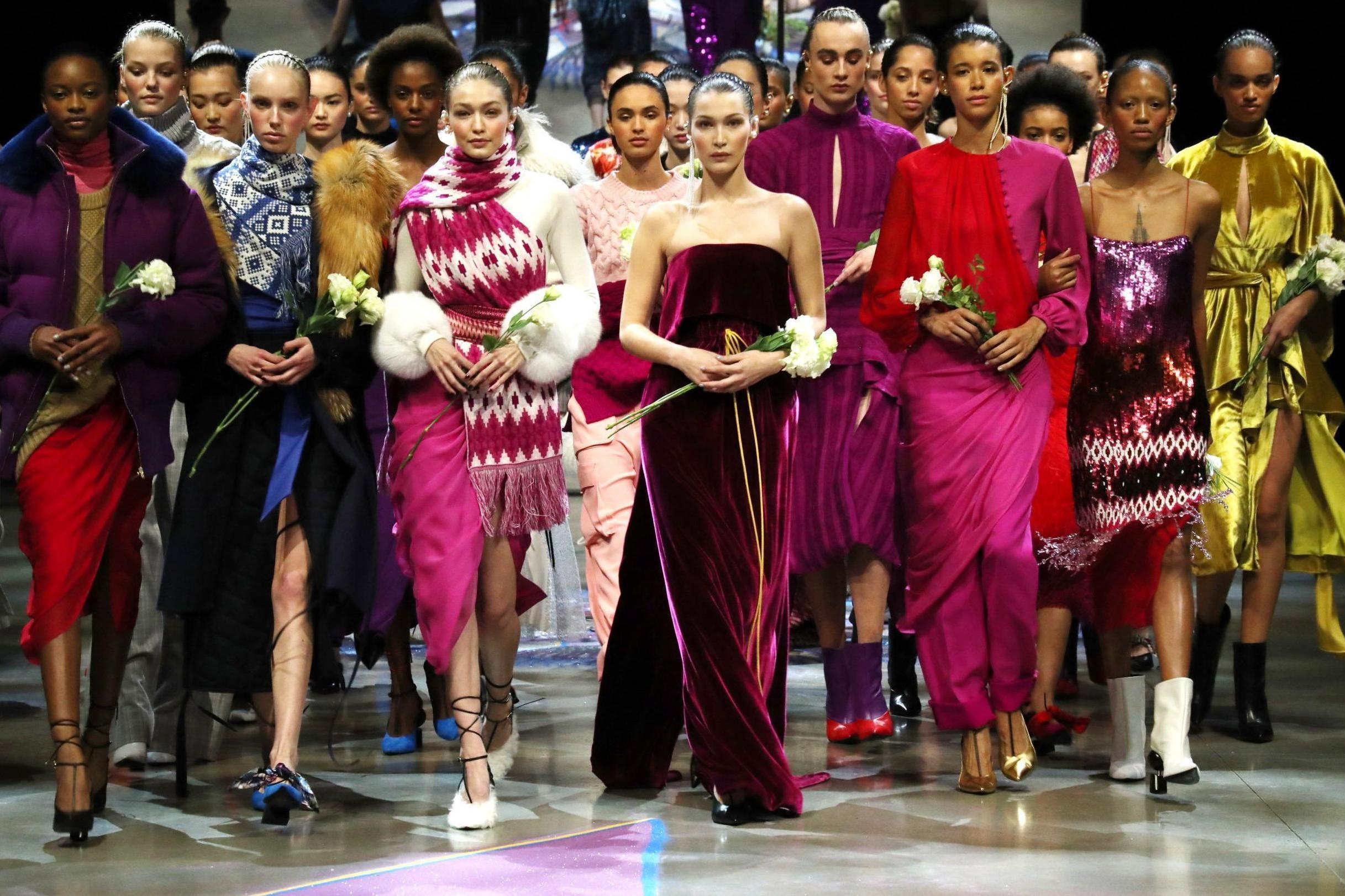 Gigi and Bella Hadid walking the runway at Prabal Gurung holding white roses in honour of #TimesUp.