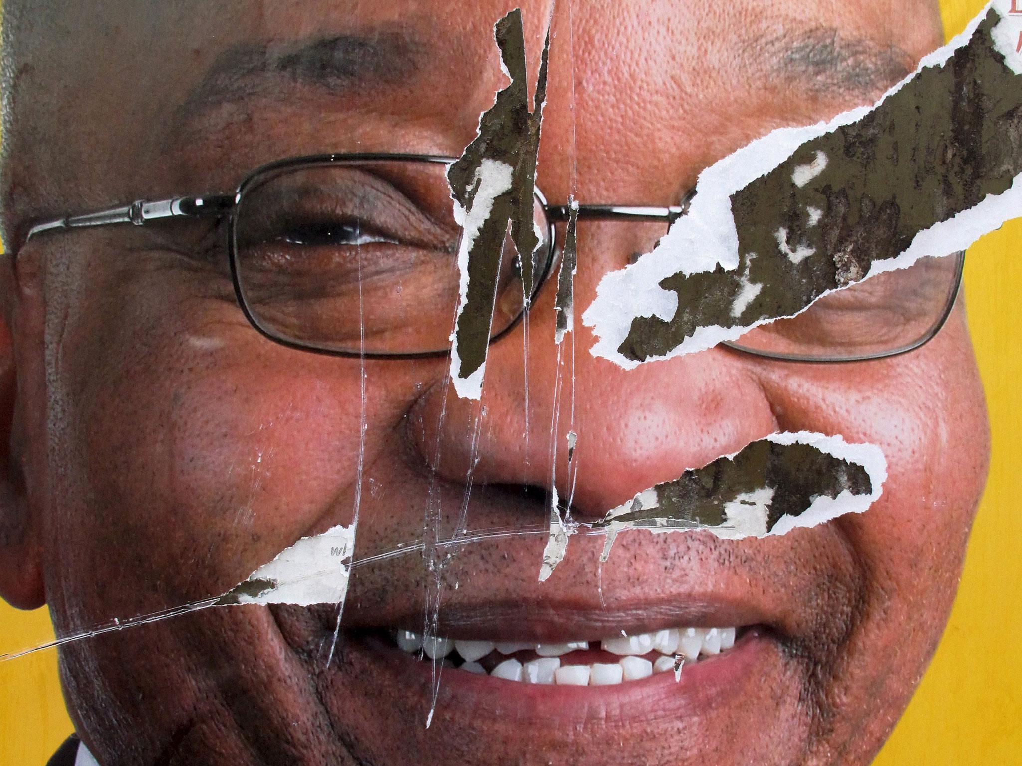 A torn African National Congress (ANC) election poster shows the face of Jacob Zuma