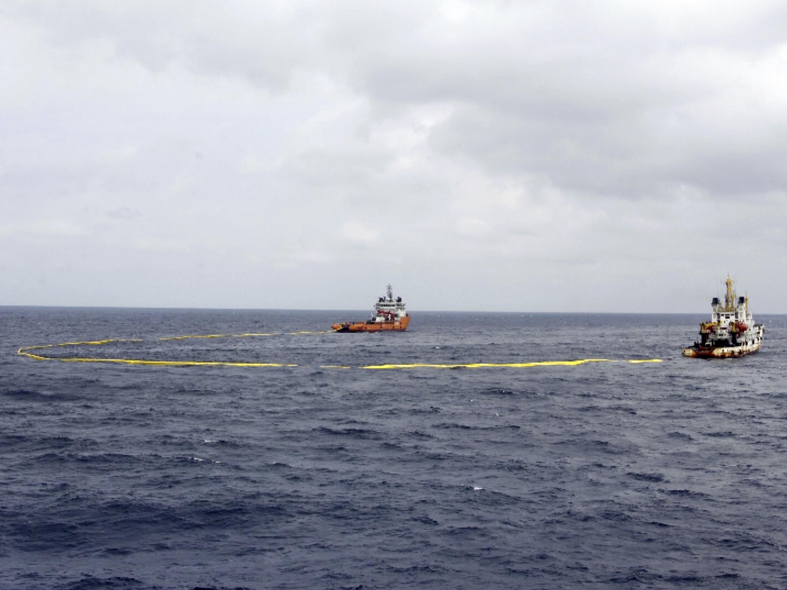 Ships work to contain an oil spill from the sunken Iranian tanker ship Sanchi in the East China Sea off the coast of China