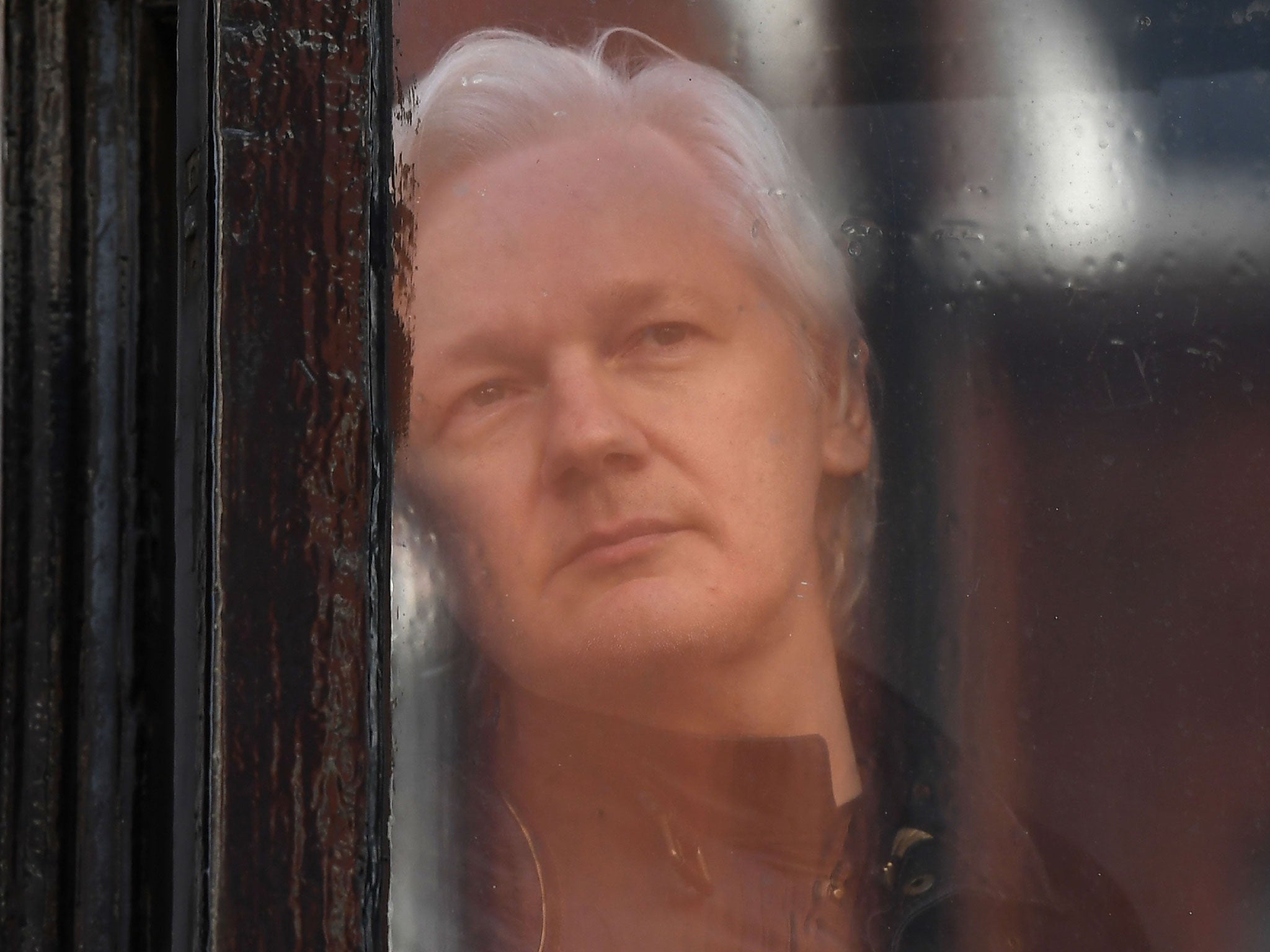 Wikileaks founder Julian Assange appears at the window at the Ecuadorian embassy in London