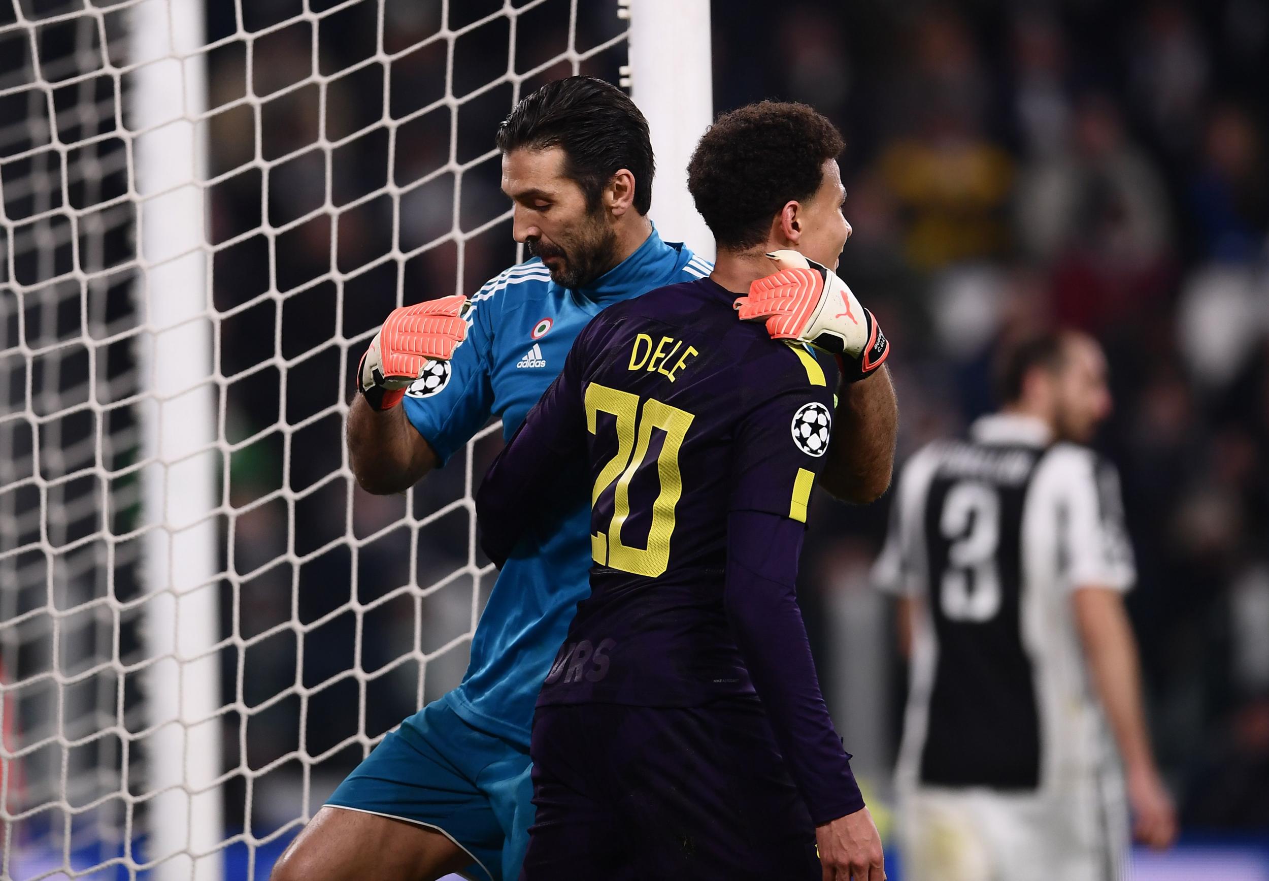 Dele Alli is embraced by Gianluigi Buffon