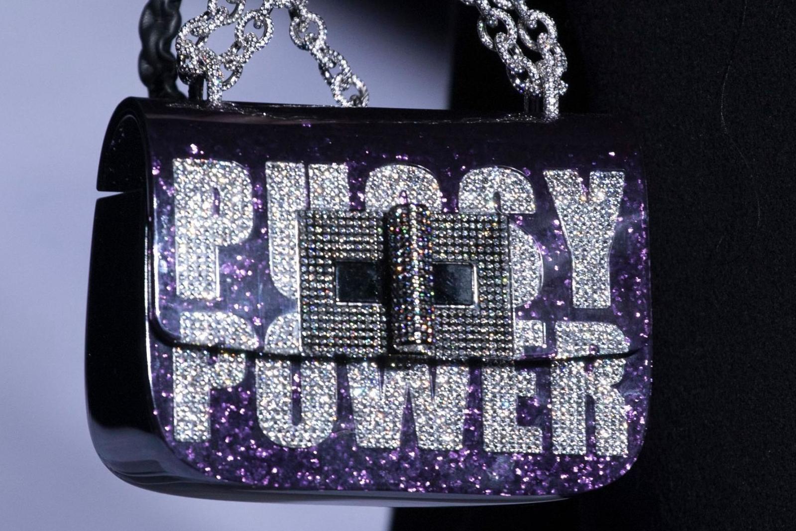 Models walked down the runway at Tom Ford holding "Pussy Power" micro-bags