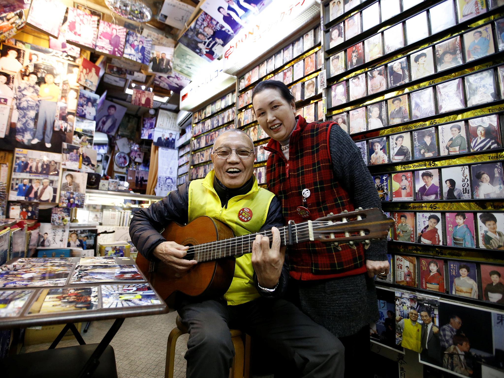 Kazuhiko Kobayashi, 80, and his wife Mieko Kobayashi, 73, pose for a photograph at their music shop named Ameyoko Rhythm, specialised for Enka, traditional Japanese popular ballad, in Tokyo's Ameyoko shopping district, Japan, February 8, 2018. "I met her in 1963, 55 years ago. She was a classmate of my younger sister. One day she came over to my house and I took a shine to her because she was so charming. Since that day on, I called her every day. In the beginning, she did not seem to be interested in me, but I conveyed my passion to her. On our first date, I waited at a meeting place for an hour. It turned out she had been advised by her mother and older sister to be late for an hour to see whether I was serious about her. My feelings got through to her, and we married on October 15, 1964, five days after the opening ceremony of the Tokyo Olympics. "