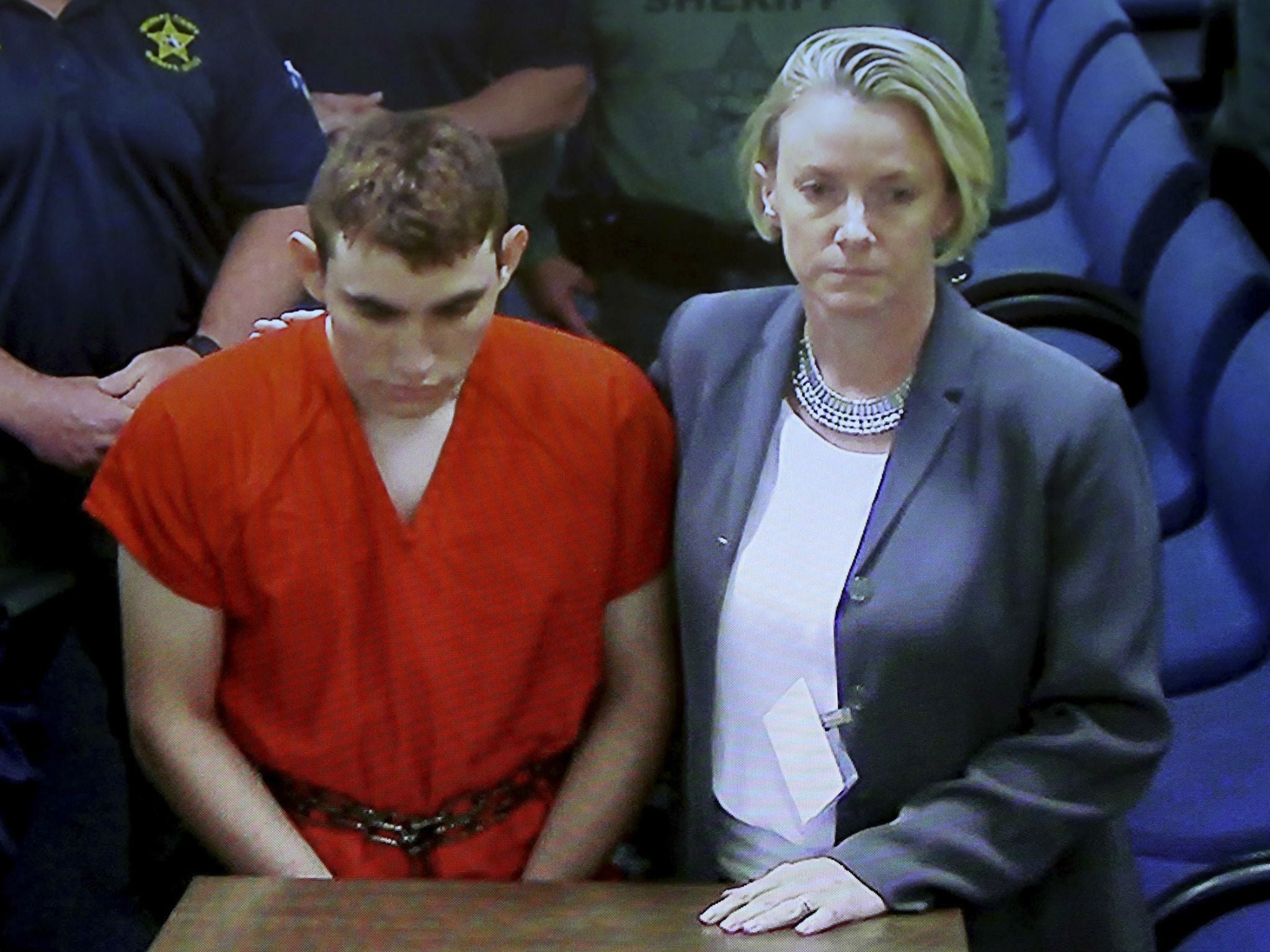 A video monitor shows school shooting suspect Nikolas Cruz making an appearance in Broward County Court