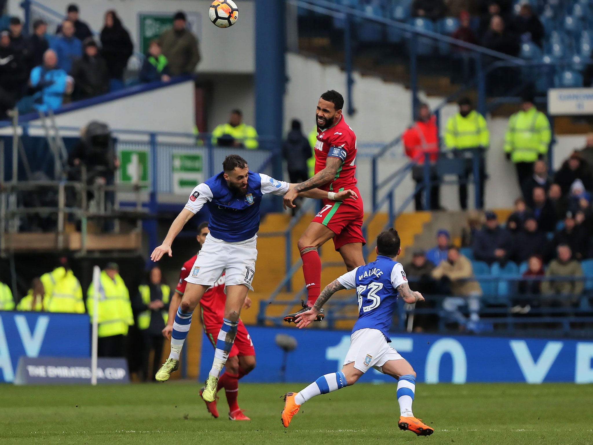 Kyle Bartley heads clear a high ball under pressure from Atdhe Nuhiu