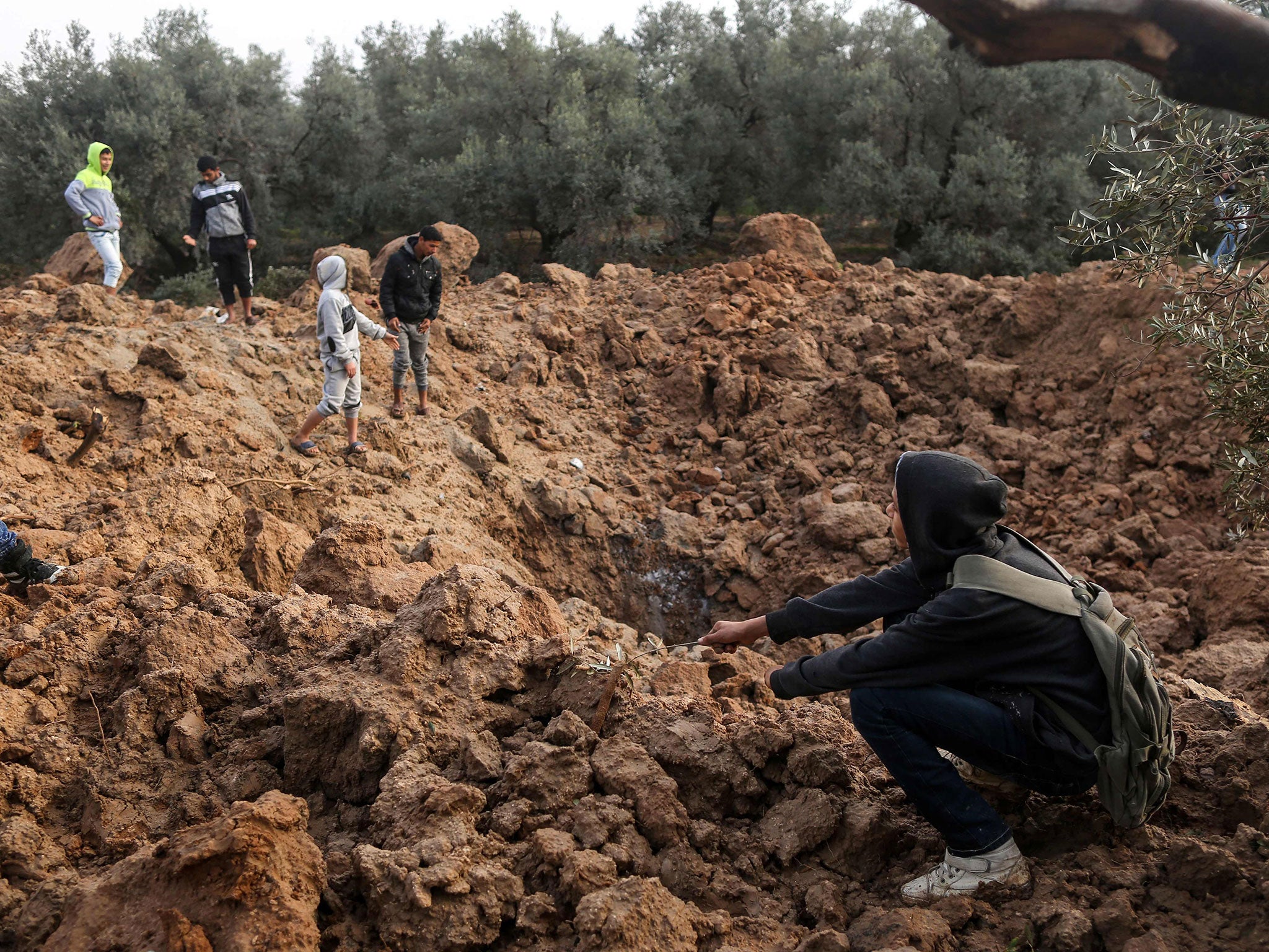 Two Palestinians were killed by Israeli fire, Gaza medical sources said, after four soldiers were wounded in an apparent bomb attack on the border with the Palestinian enclave