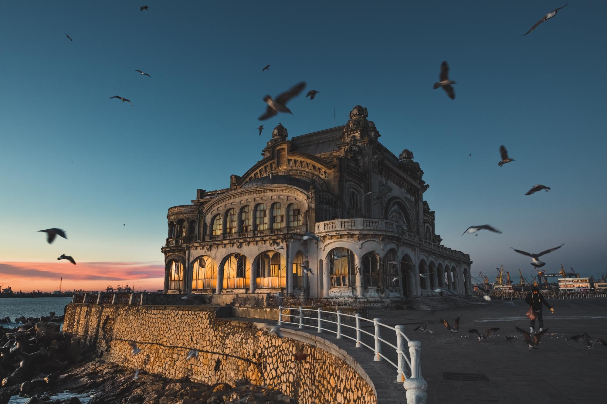 Birds circling Constanta Casino at dawn