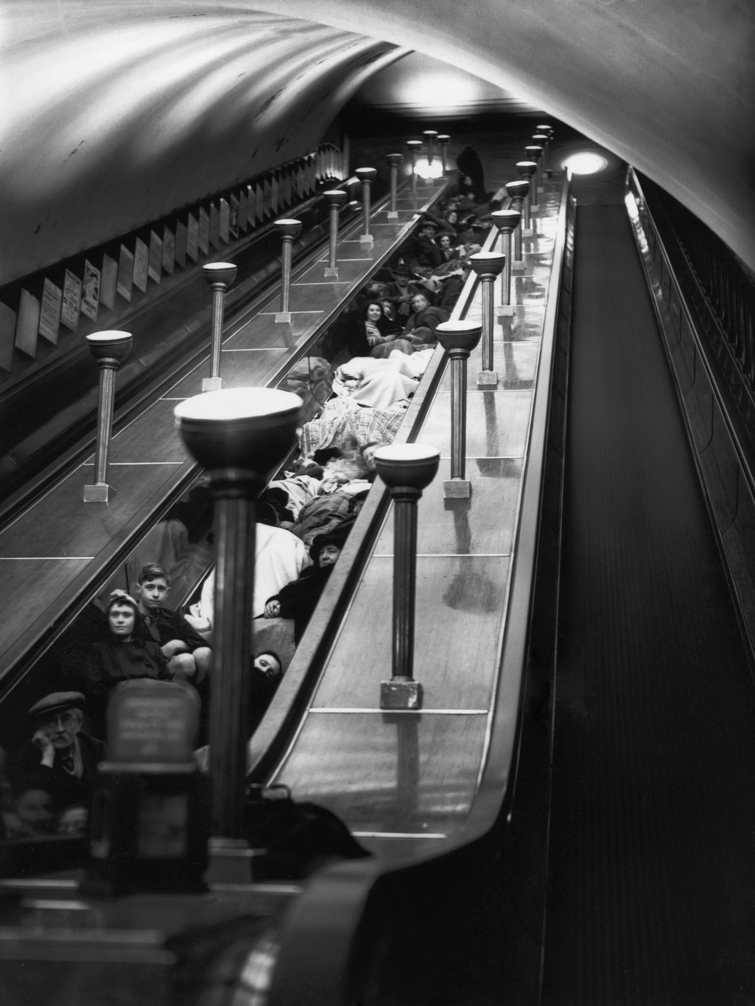 Londoners sheltering from an air-raid on the stairs between escalators at Bounds Green underground station, 11 October 1940