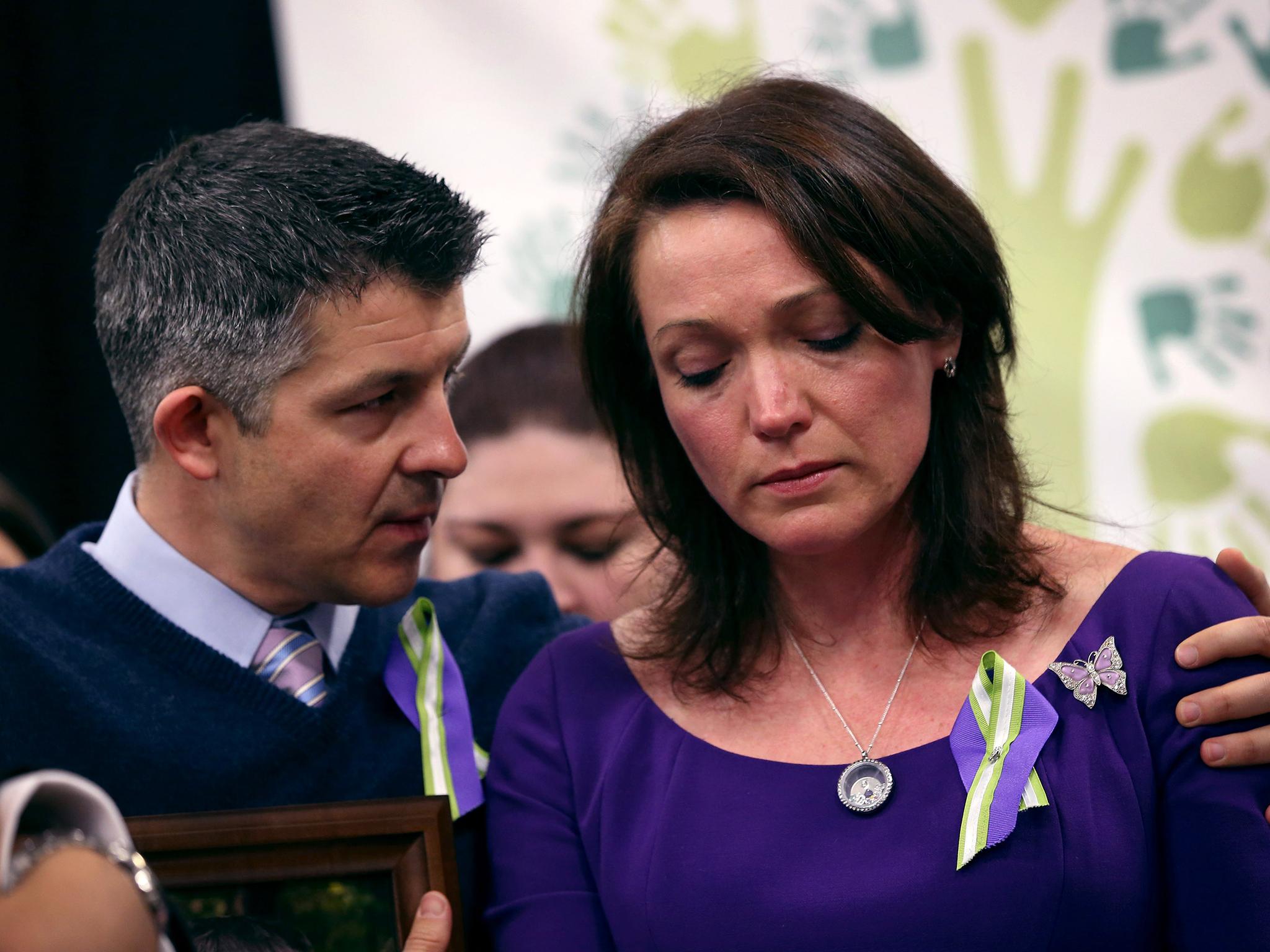 Ian and Nicole Hockley, whose son Dylan (six) was killed in the Sandy Hook massacre, embrace during a press conference with fellow parents of victims