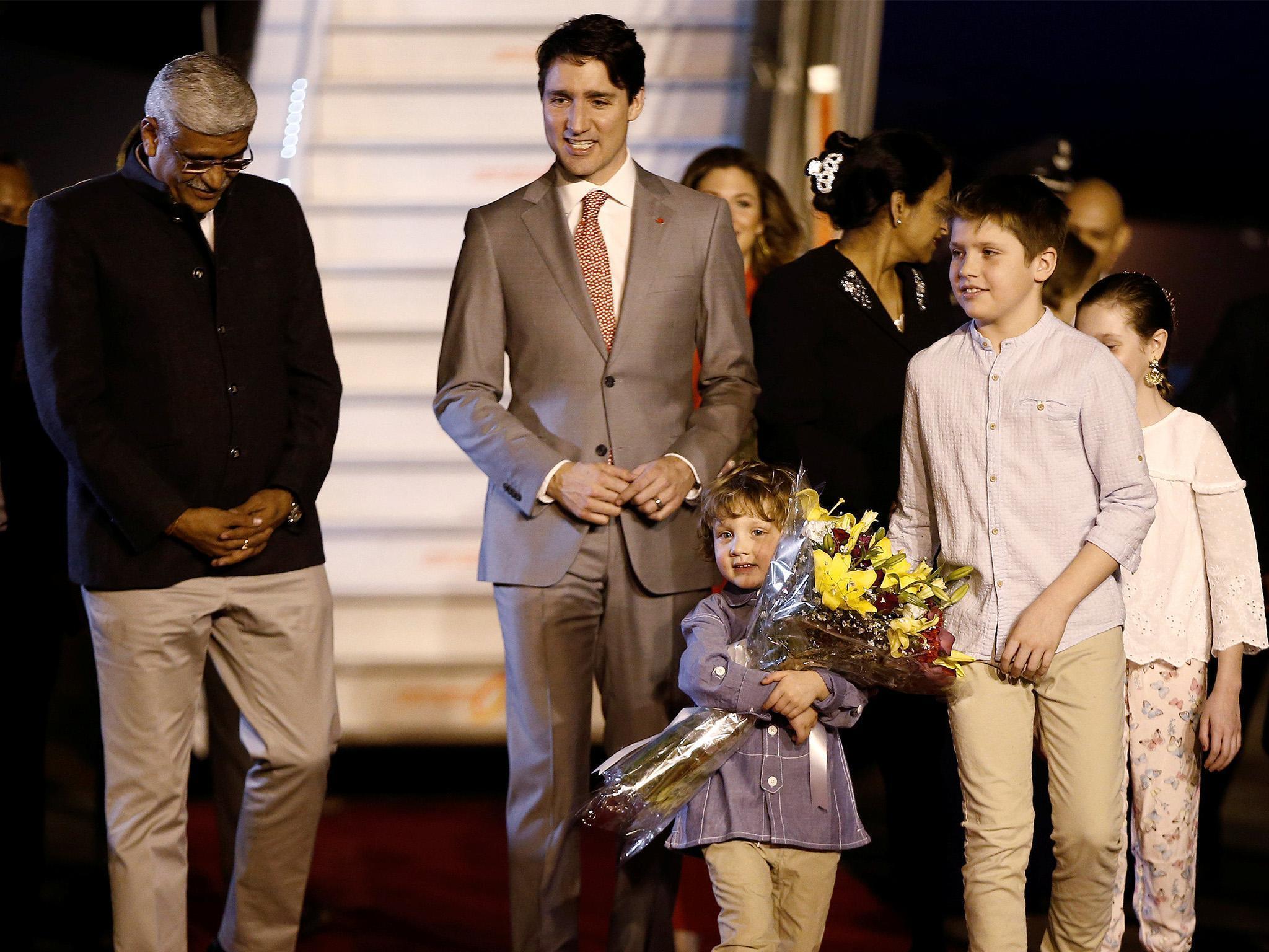 Justin Trudeau and his family are welcomed by a junior minister on arrival in India