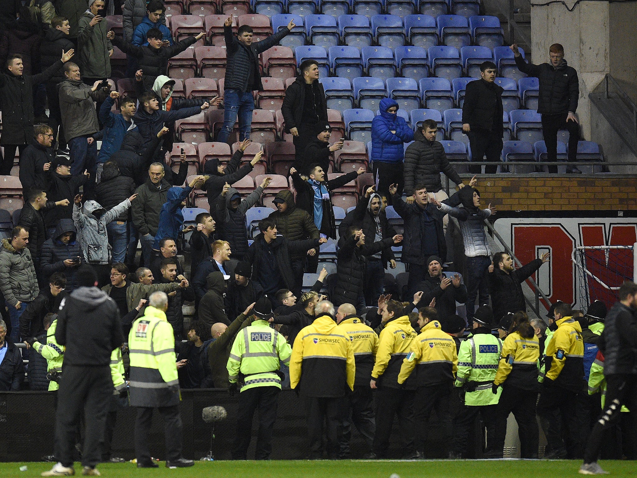 Manchester City fans clashed with police, stewards and rival Wigan supporters