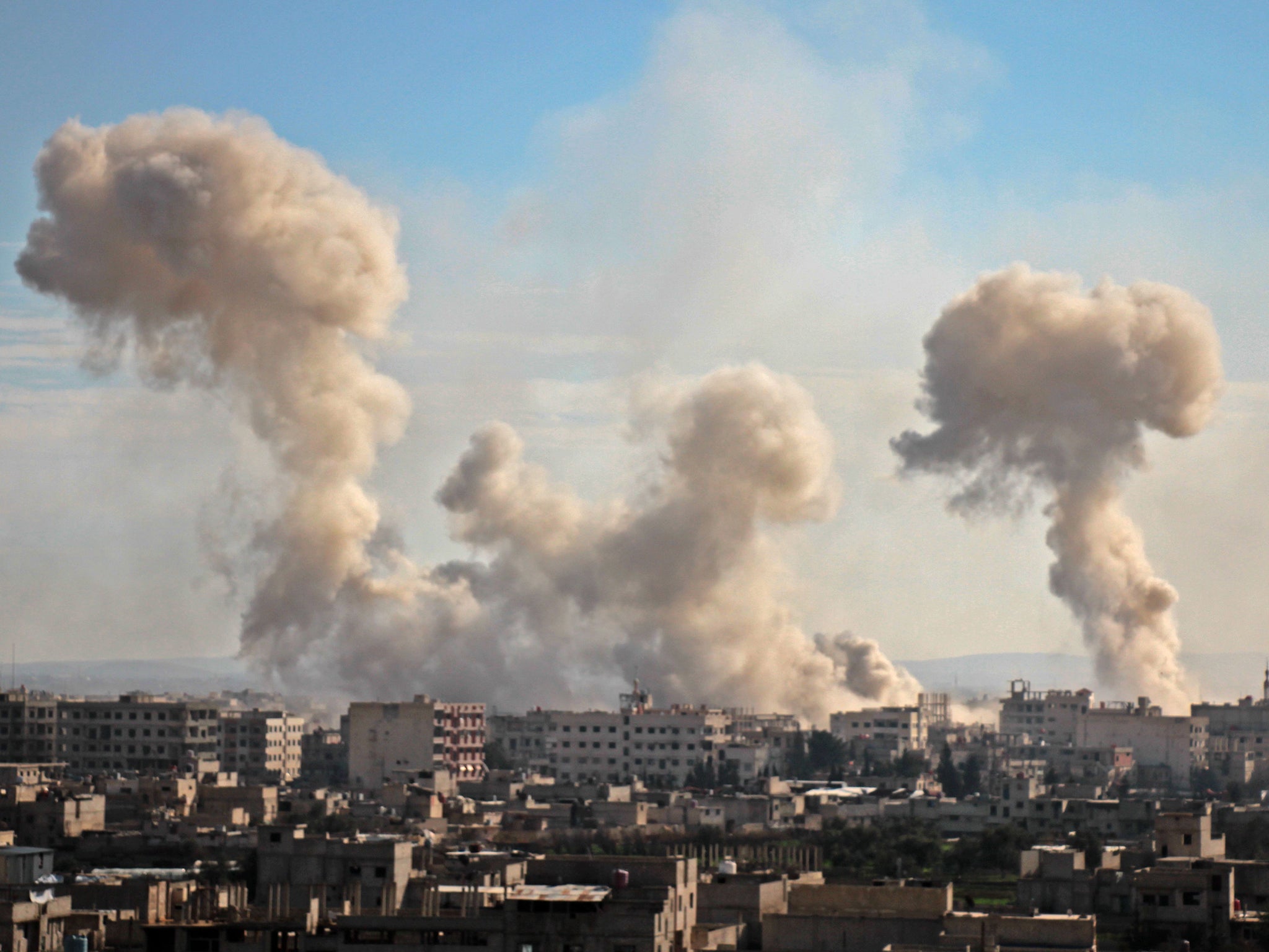 Smoke rises from buildings following the attack on the village of Mesraba in the rebel-held besieged Eastern Ghouta region on the outskirts of the capital Damascus (AMZA AL-AJWEH/AFP/Getty Images)