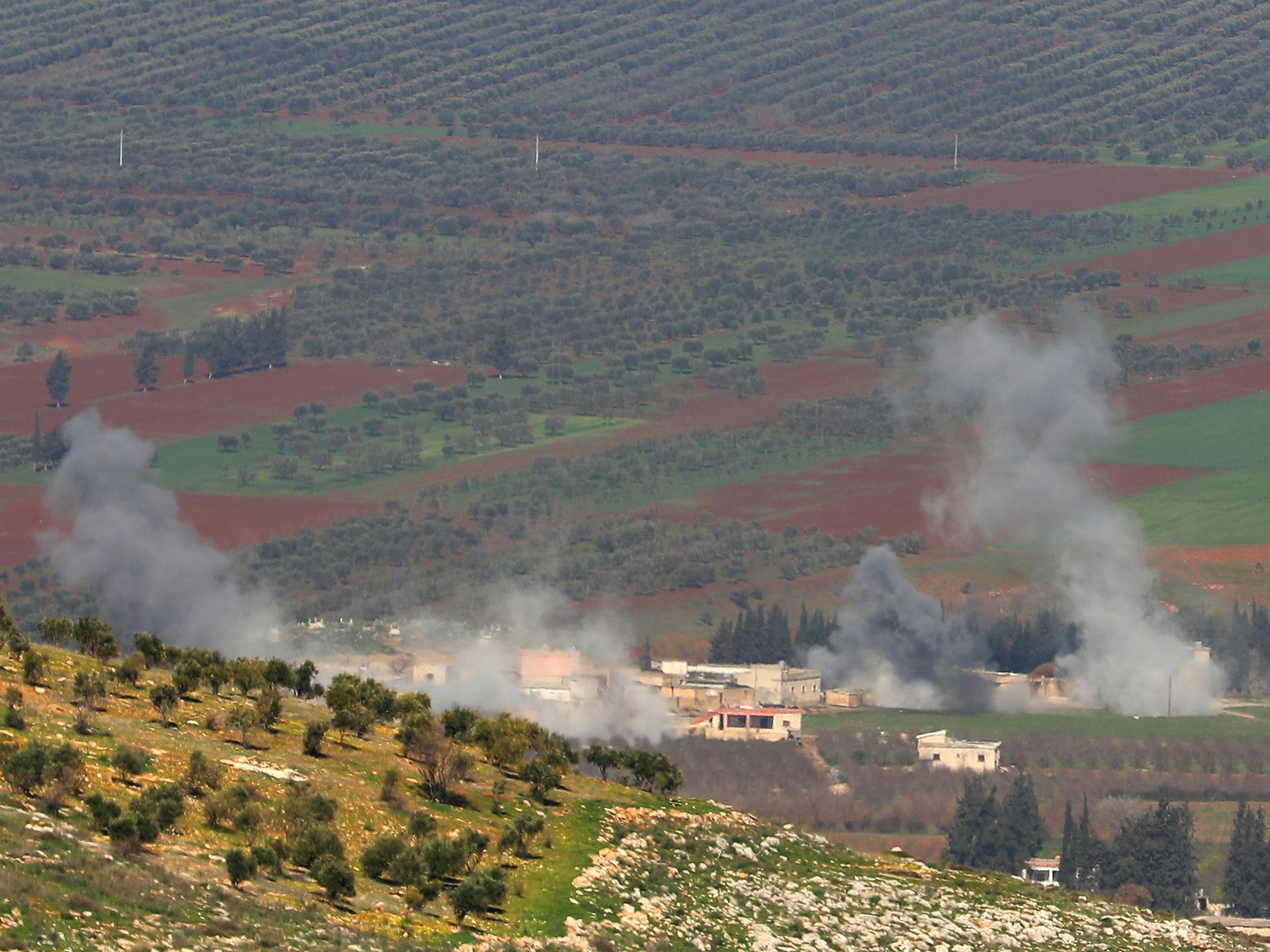 Turkish-backed Syrian rebel fighters fire from the town of Salwah, less than 10 kilometres from the Syria-Turkey border, towards Kurdish forces from the People's Protection Units (YPG) in the Afrin region.