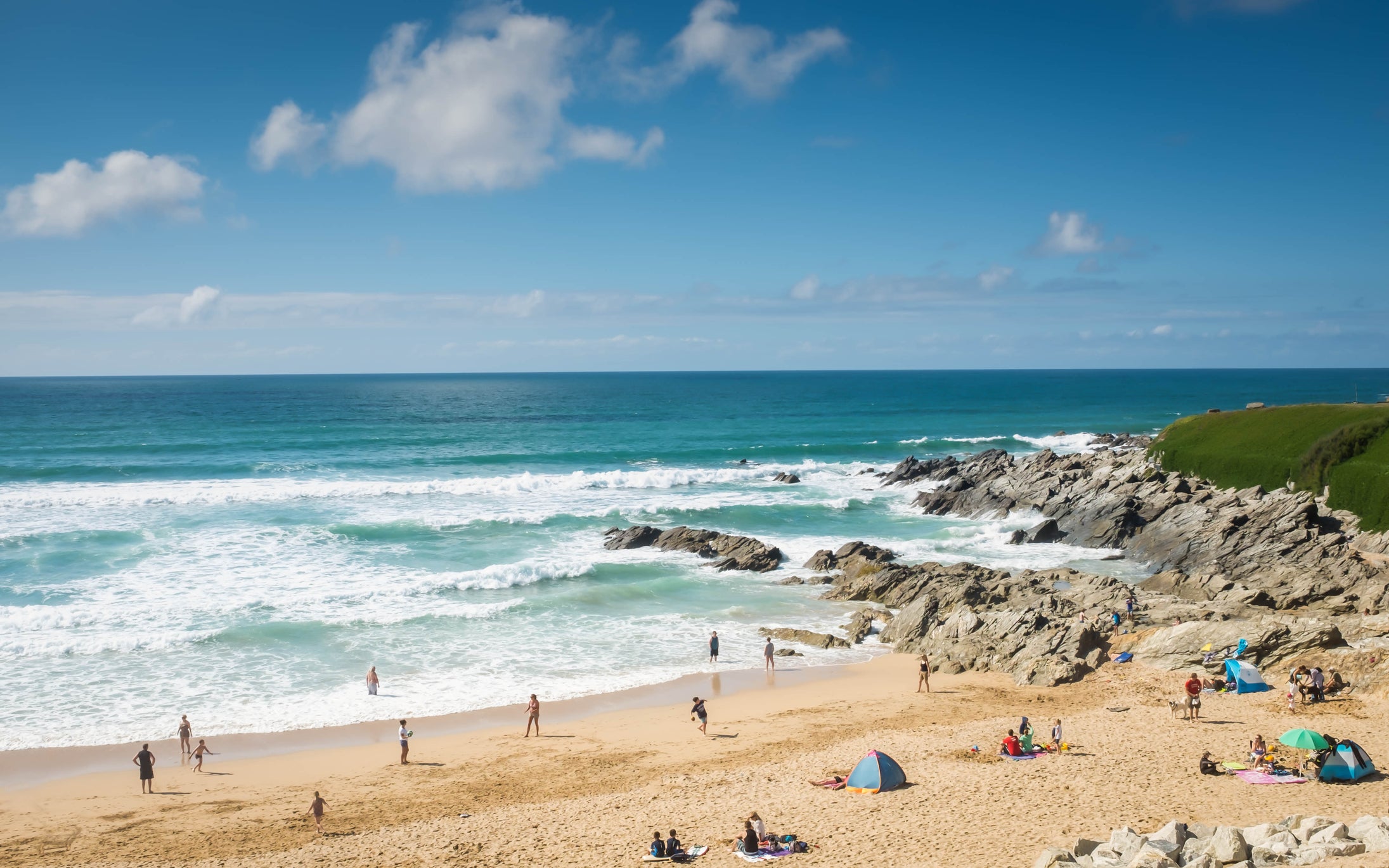 Families enjoying their holiday on Fistral beach, Cornwall, England.