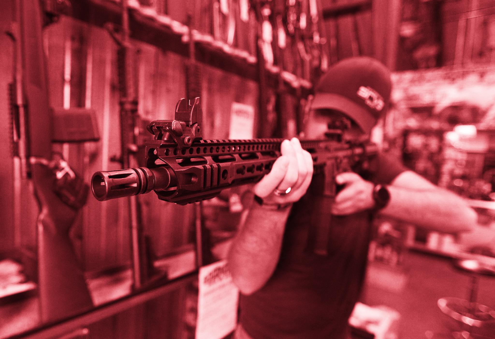 Dordon Brack, aims a semi-automatic AR-15 that is for sale at Good Guys Guns Range on February 15, 2018 in Orem, Utah