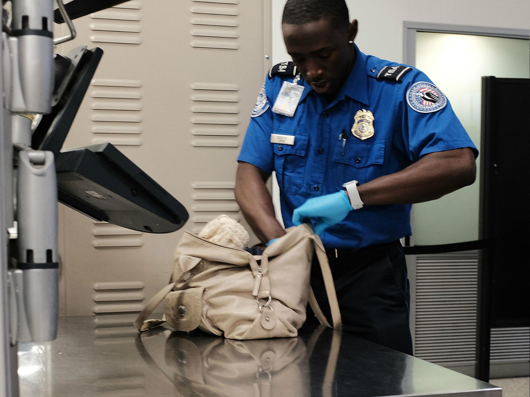 A Transportation Security Administration (TSA) worker screens passengers