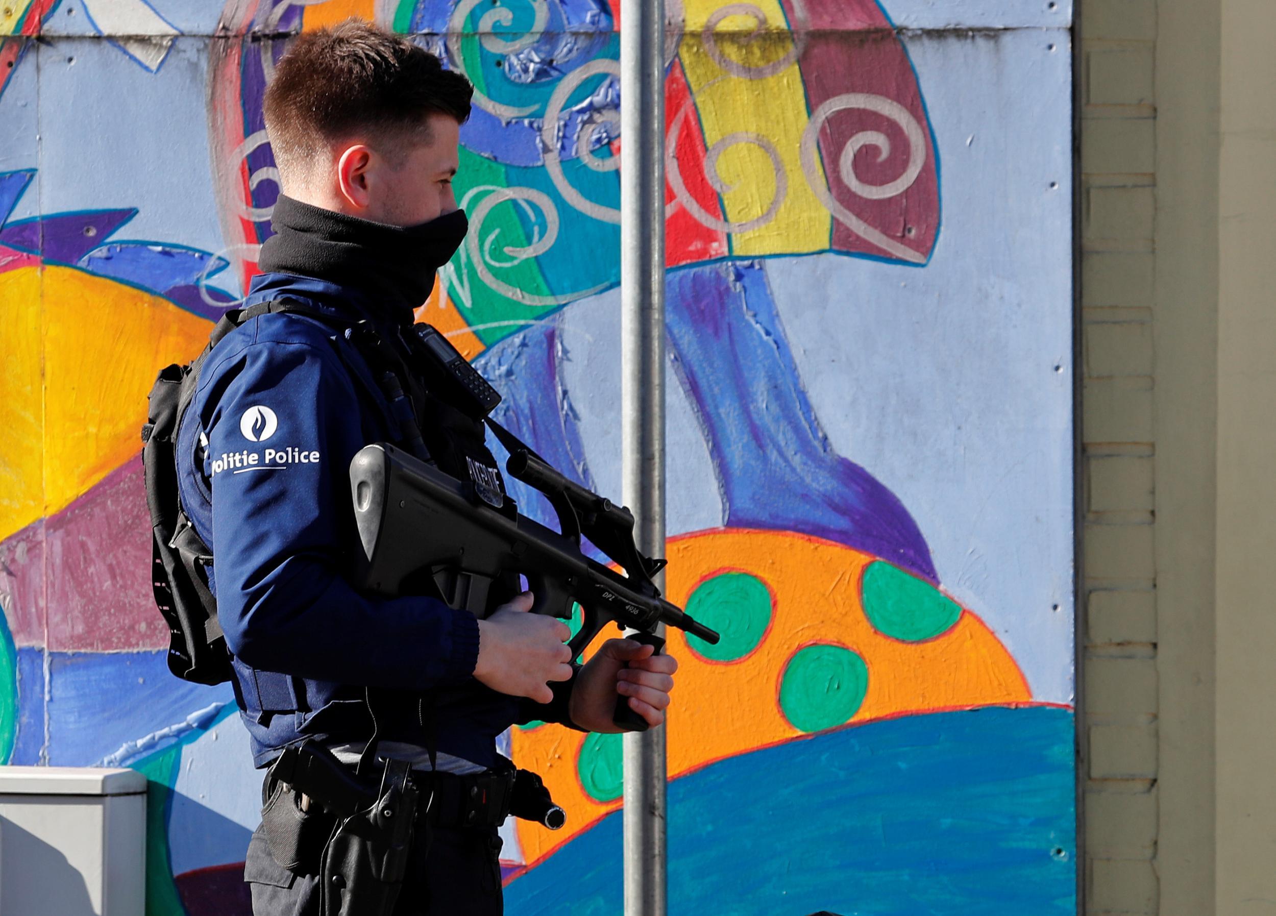 A Belgian police special forces member secures a street after an area of the Forest commune in Brussels was put on lockdown