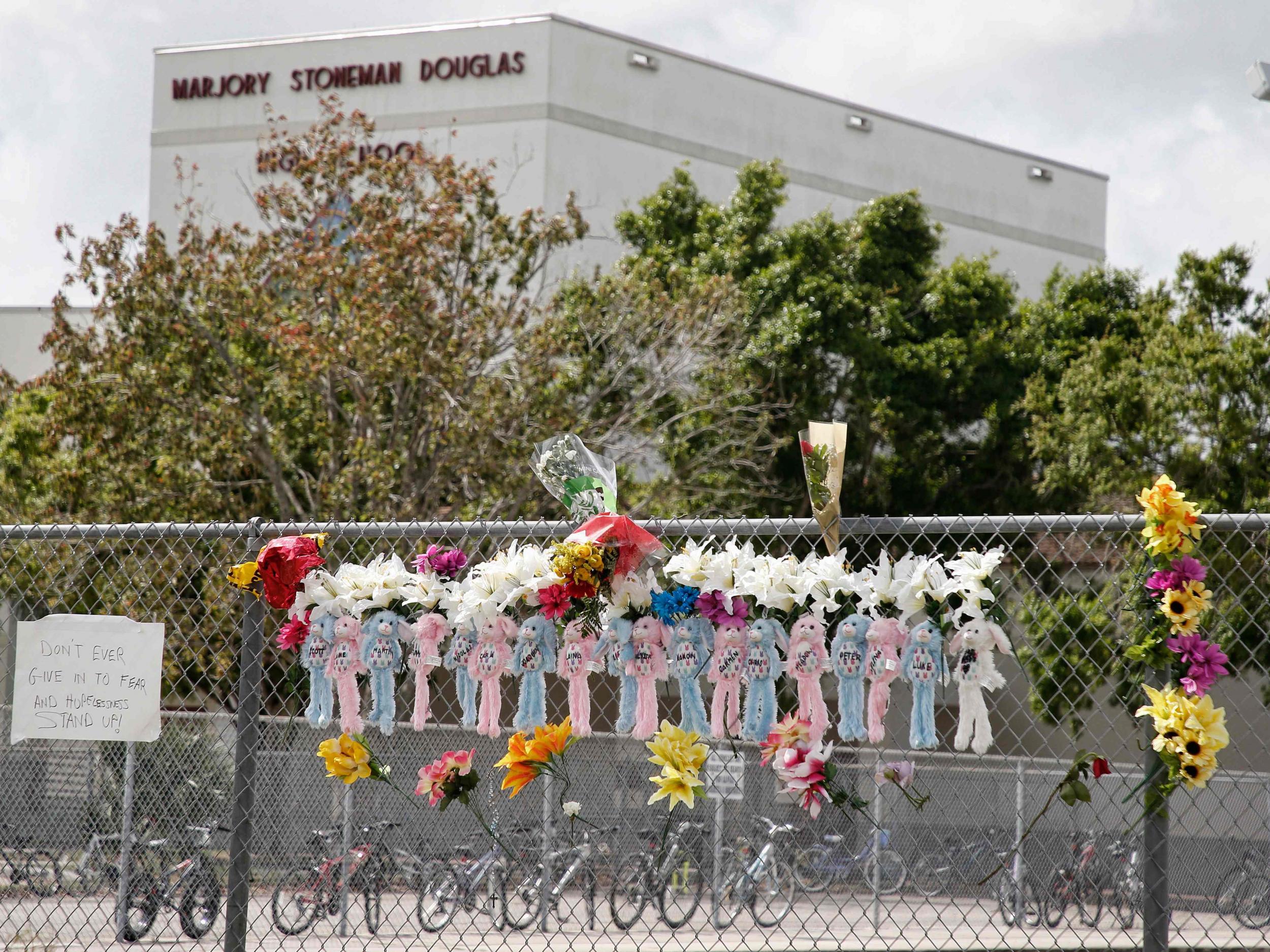 Memorials to shooting victims are seen on a fence surrounding Marjory Stoneman Douglas High School in Parkland, Florida (AFP/Getty Images)