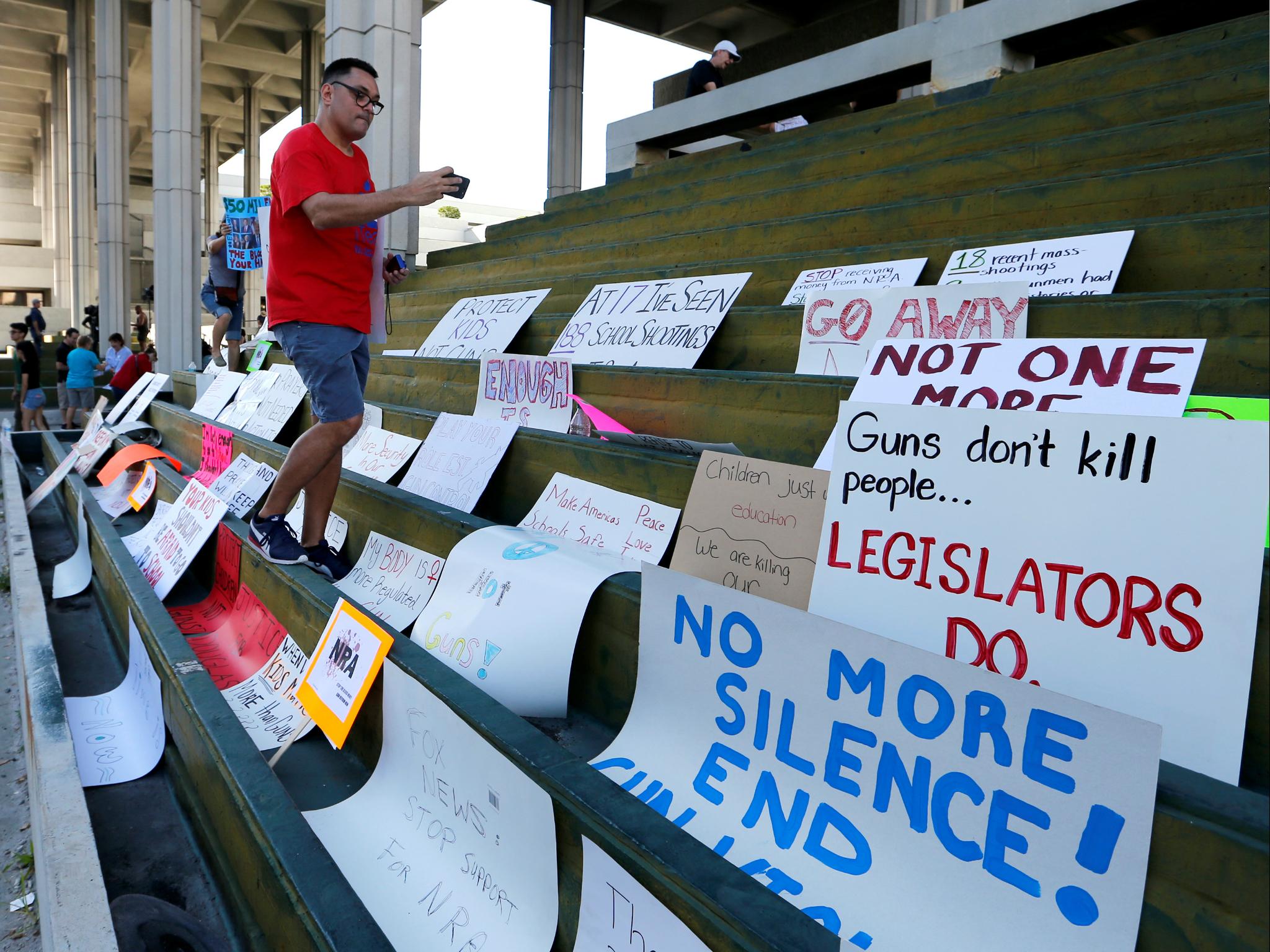 Signs left during a march at the US Courthouse in Fort Lauderdale, Florida (REUTERS/Joe Skipper)