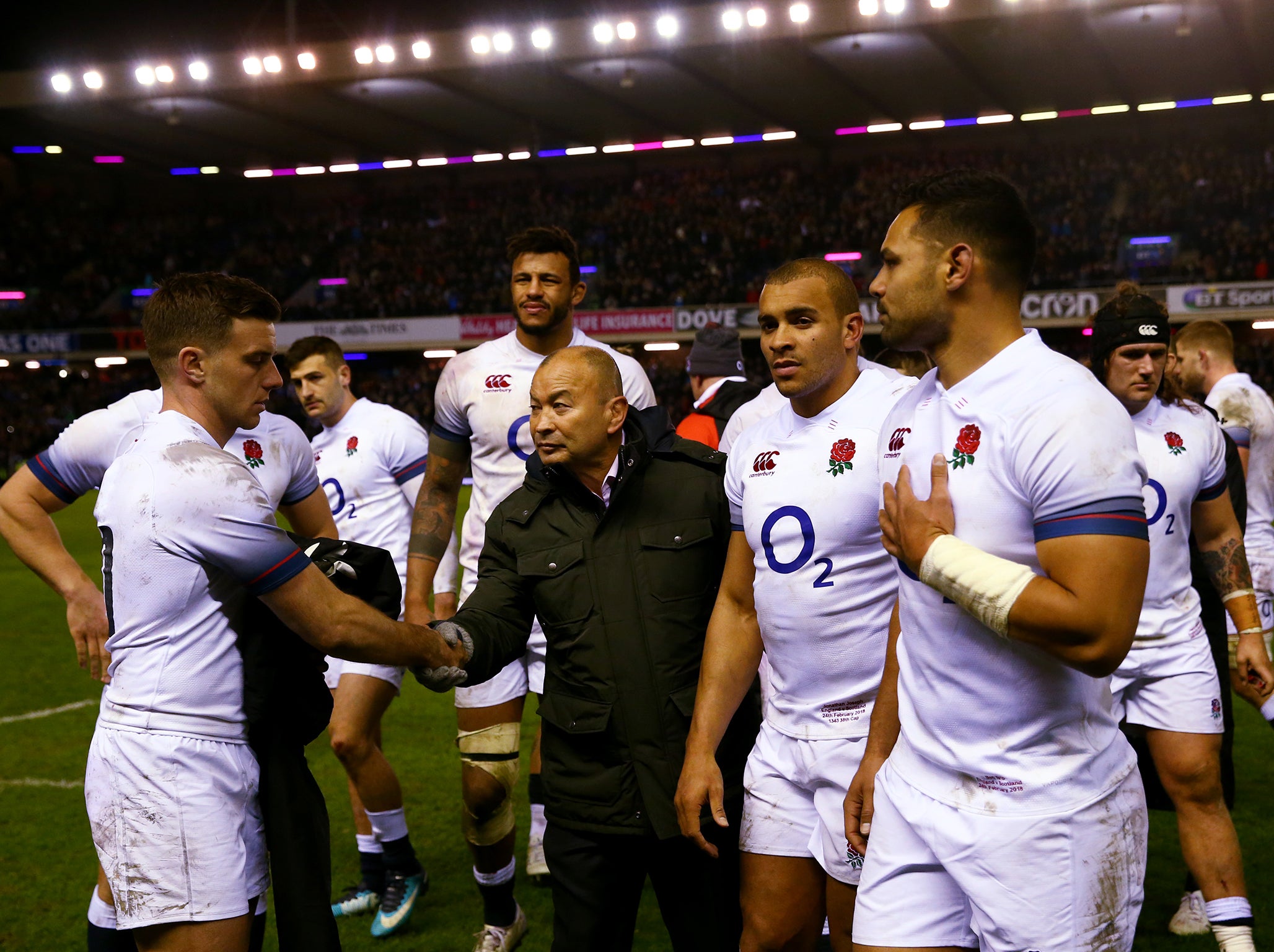 Eddie Jones commiserates his players after defeat by Scotland