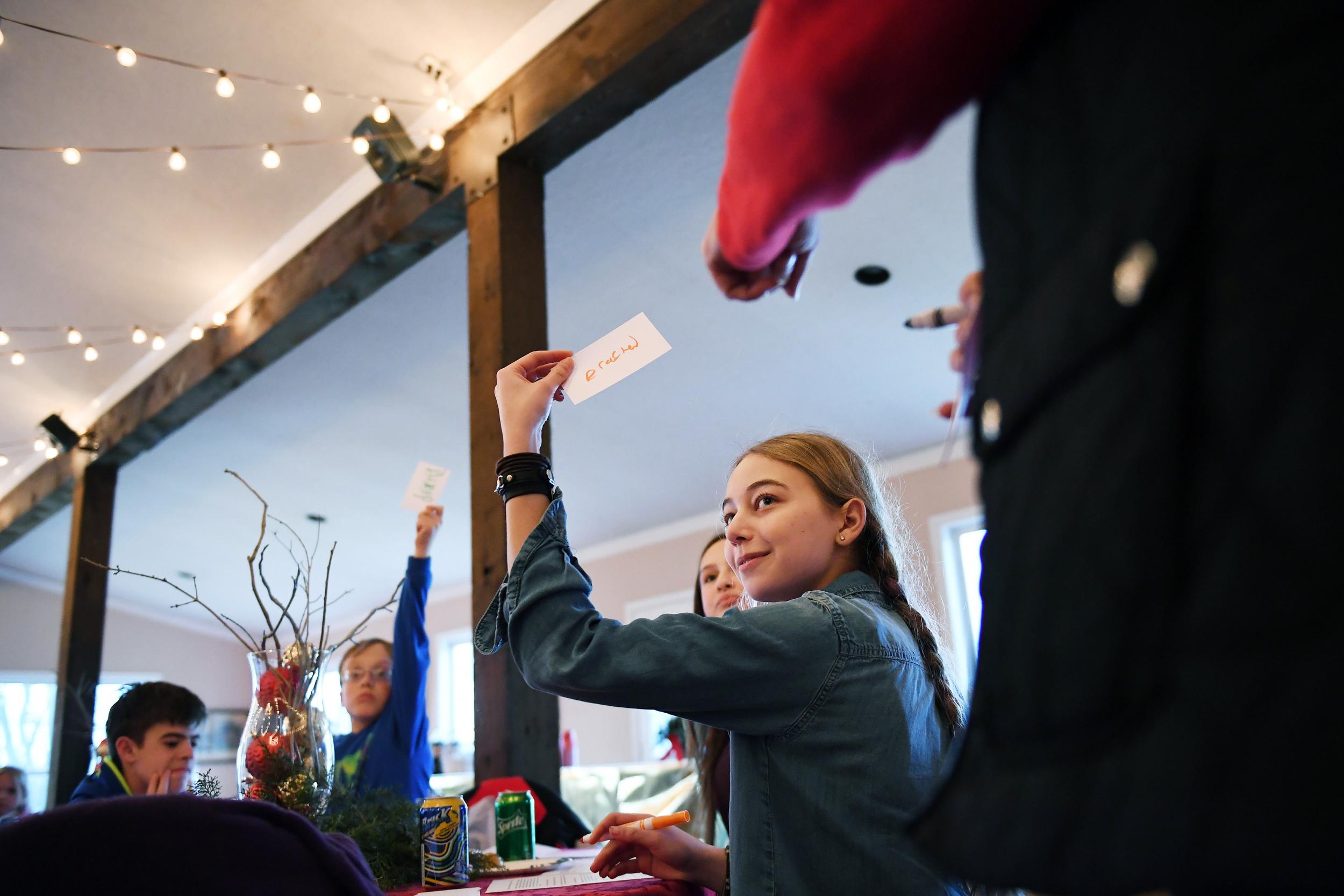 Rachael Kern, 17, plays a trivia game about fox hunting terminology during a December holiday party for junior members of the Potomac Hunt