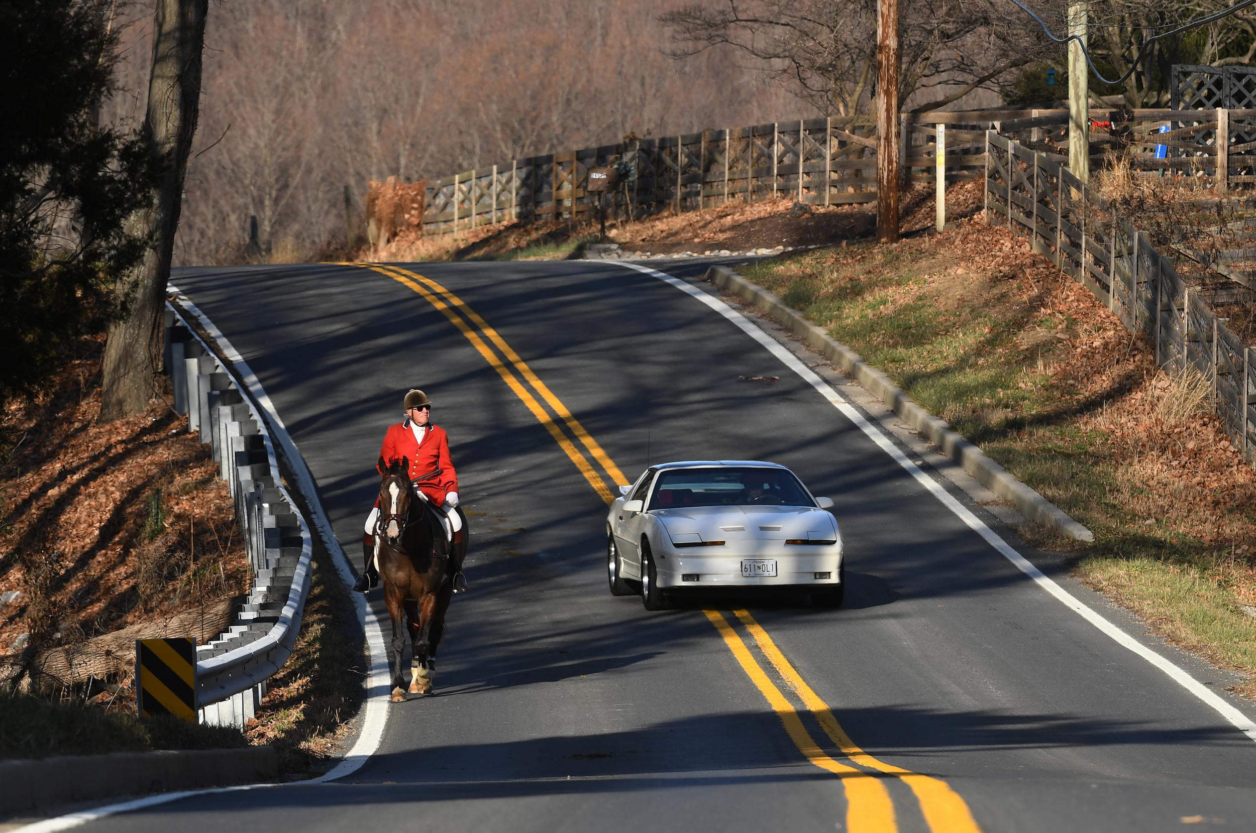 Allen Forney rides on a road in during a fox hunt with the Potomac Hunt Club