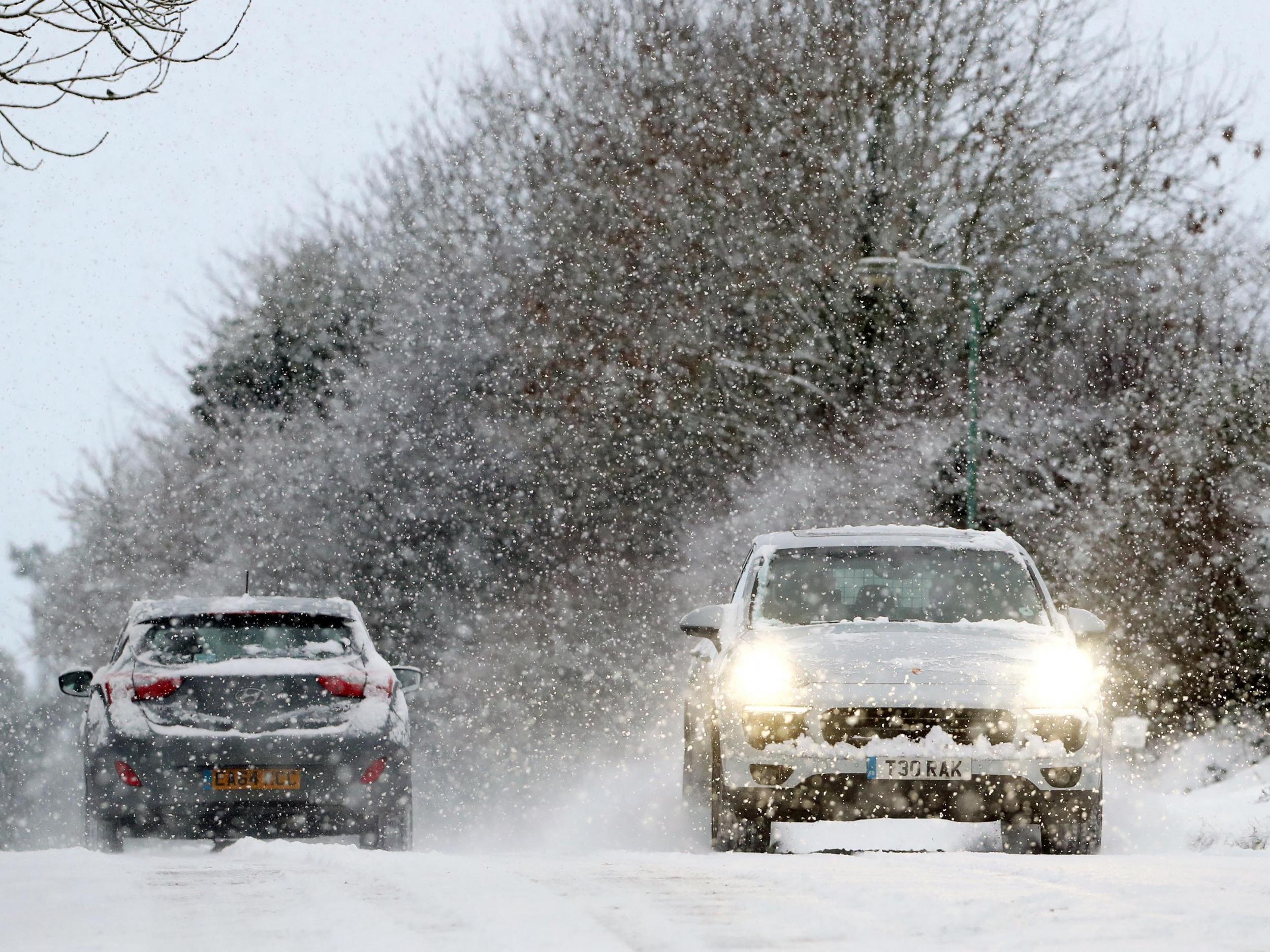 Cars travel through Great Chart in Ashford, Kent, following heavy overnight snowfall